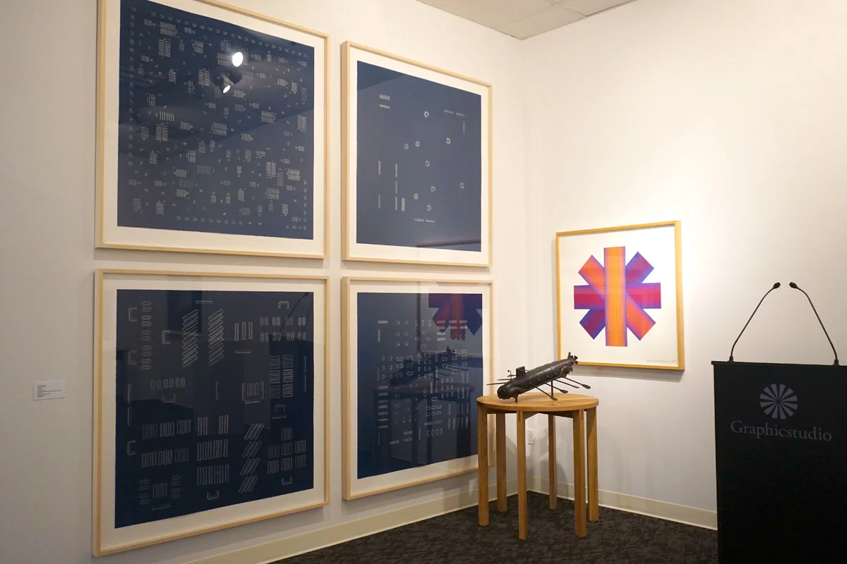 © 2019 Louise Levergneux. left : Guillermo Kuitca, The Neufert Suite , 2002, suite of six cyanotypes 46.5 x 46.5”; right top : Richard Anuszkiewicz, Blue Tinted Star , 1991, Five-color lithograph / screen-print assemblage, 36 x 38 x 1.062”; on pedestal (H 33.25” x diam 33”): Esterio Segura, Submarine Homemade , 2018, bronze with applied patina and white oak pedestal, 12.75 x 26 x 29”.