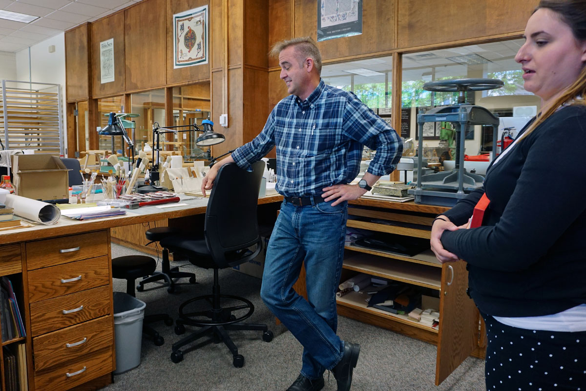 © 2019 Louise Levergneux. Chris at his work station in the conservation lab of the Harold B. Lee Library.
