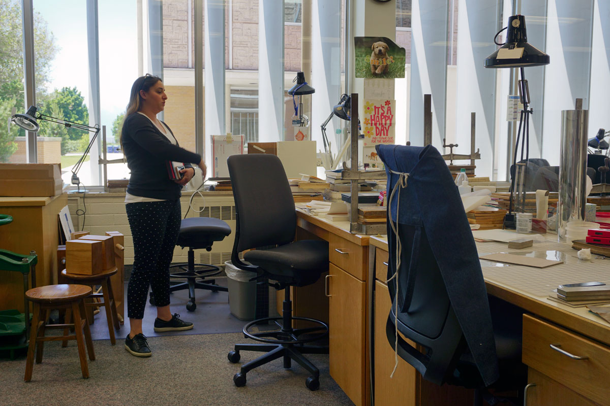 © 2019 Louise Levergneux. Victoria Birth, Binding Supervisor in front of her desk at the Harold B. Lee Library’s Book Repair Unit.