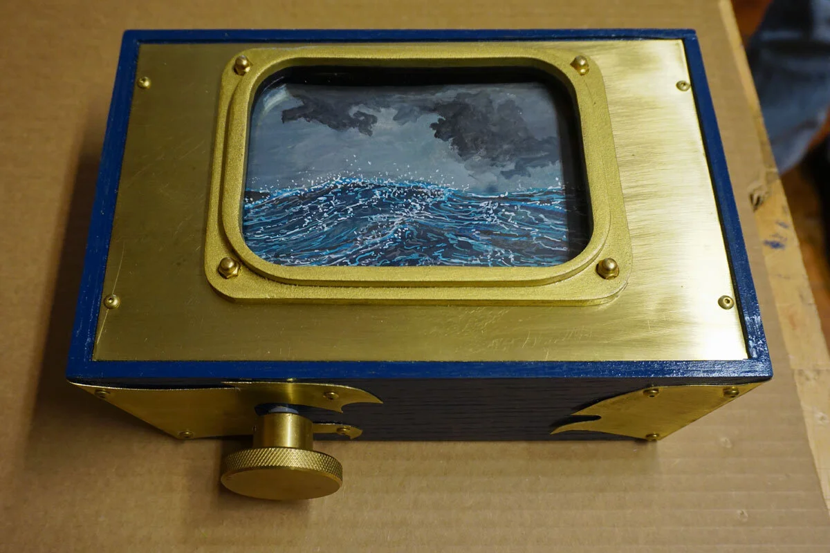 © 2019 Louise Levergneux. Voyage by Thomas Parker Williams, edition of 3, No. 1, 2 & 3 - original scroll water colour and ink paintings on tyvek; scroll dimensions 5" x 120" enclosed in a wood container with brass handwheel, panel and mechanical parts.