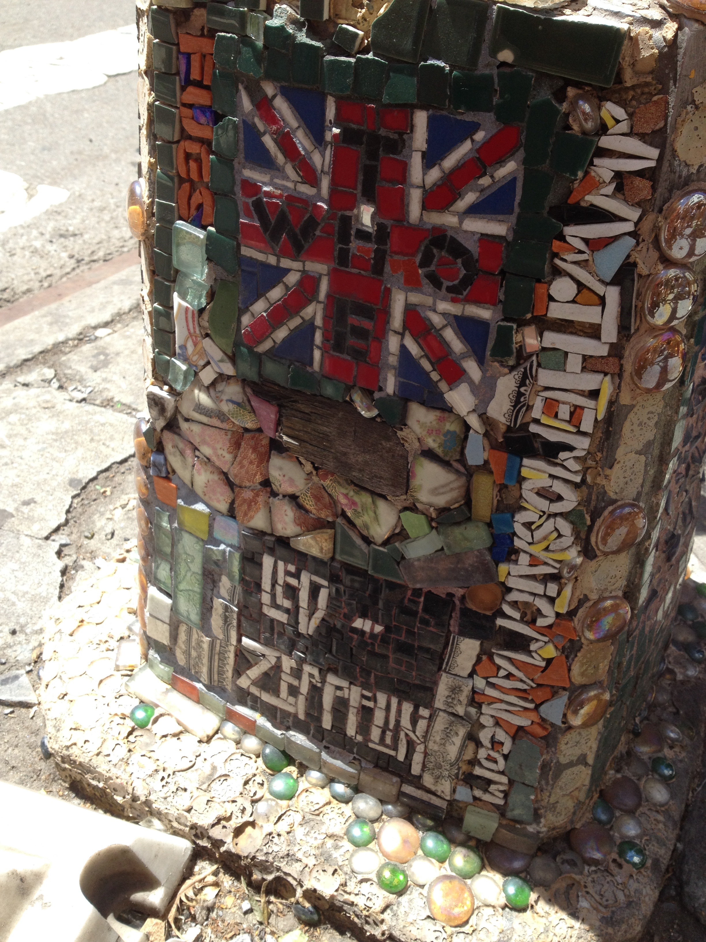 A piece of Pete Townshend's guitar is between the Union Jack and the Led Zeppelin logo.