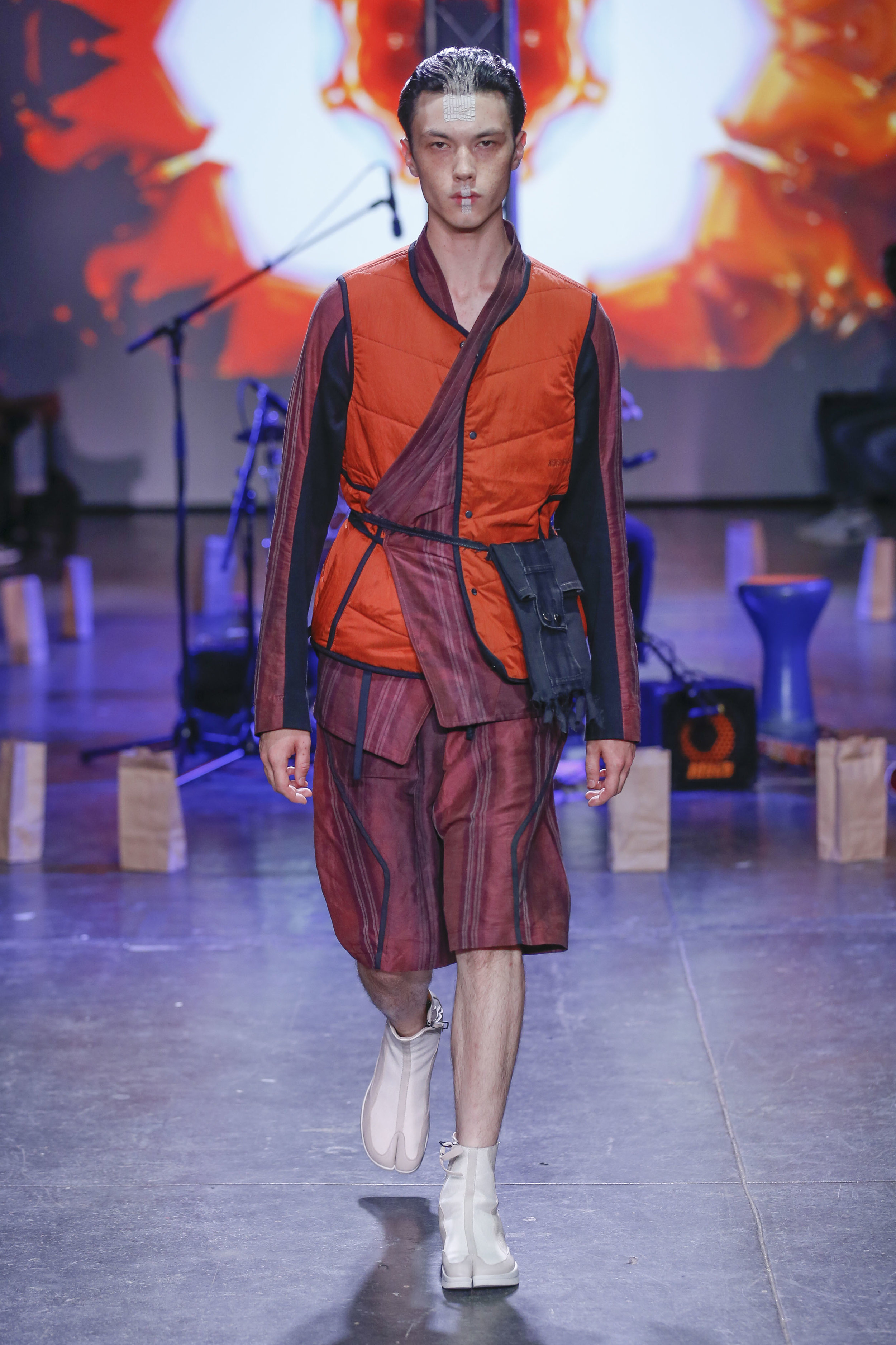  LOOK 19   ARC Atlas Vest  / Orange   ARC Kimono Shirt  / Maroon Stripe   ARC Kyoto Short  / Maroon Stripe   ARC Shoulder Bag  (Worn on Waist)   ARC Apollo Tabi Boot  