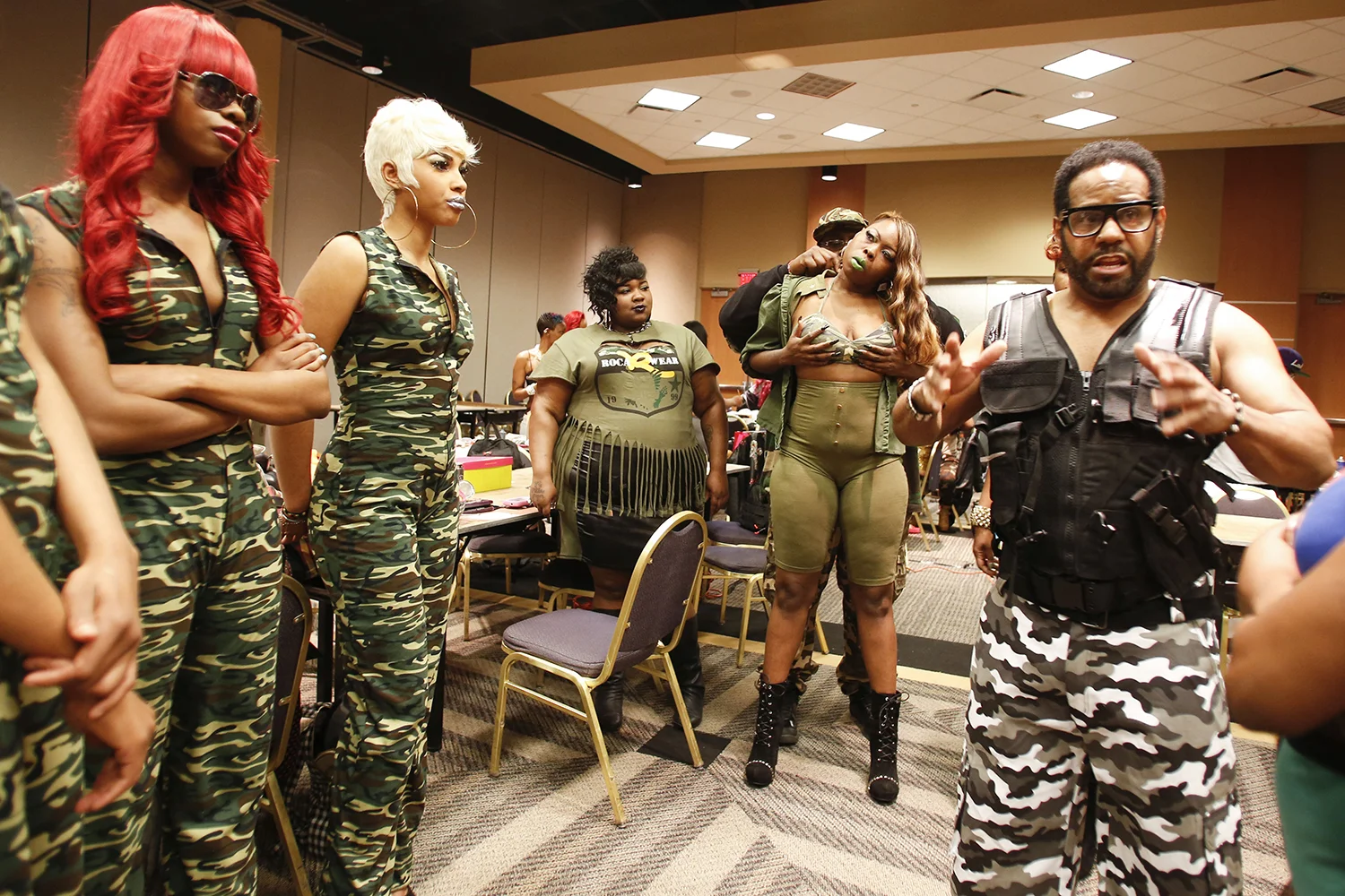 Anthony Stewart, 35, center left, assists Keya Pearson, 35, center right, with her costume before taking the stage for Hair Wars on Sunday, May 4, 2014 at the Adoba Hotel in Dearborn. Tim Galloway for Al Jazeera America