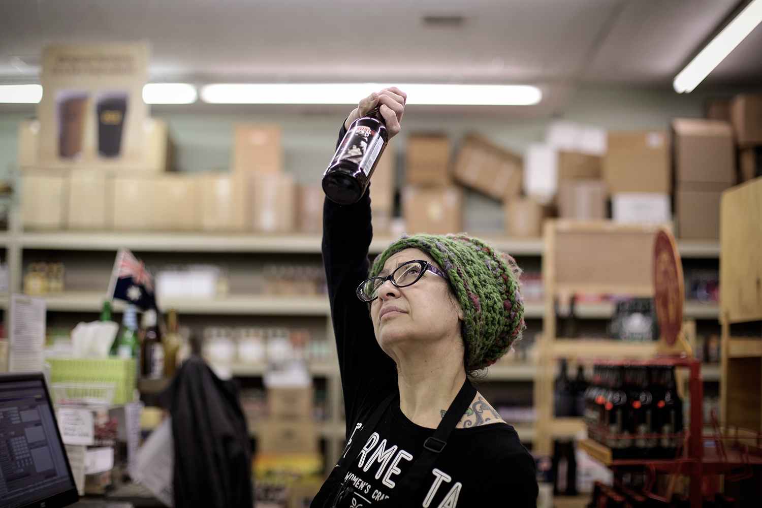 Annette May from Allen Park holds a bottle of beer up to the light to determine what type of beer it is at Merchant's Fine Wine on Wednesday, Feb. 4, 2015 in Dearborn. May is the first Cicerone certified woman in the State of Michigan and is involved with Fermenta, a Michigan women's craft collective. Tim Galloway/Special for DFP