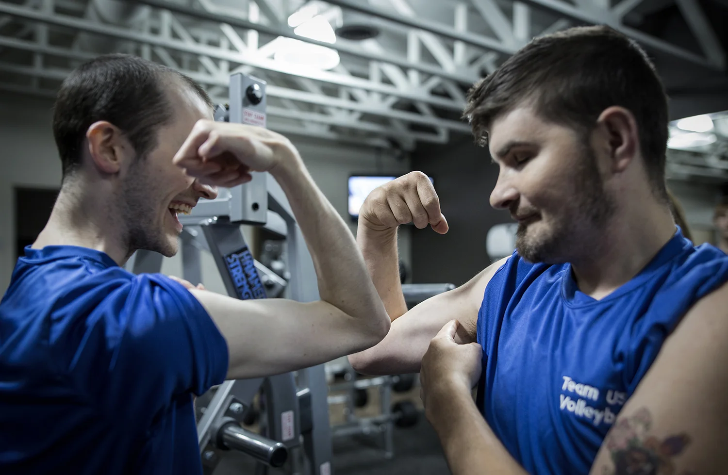 Grand Blanc, MI - Thursday, June 25, 2015: Brett Rife, left, from Flint, MI and Joe Gross from Montrose, MI show off and compare their muscles during their training session at Anytime Fitness in Grand Blanc, MI. The Michigan Special Olympics Volleyball Team has been preparing for the 2015 Special Olympics Summer Games in Los Angeles, CA beginning July 25. (Tim Galloway for ESPN)