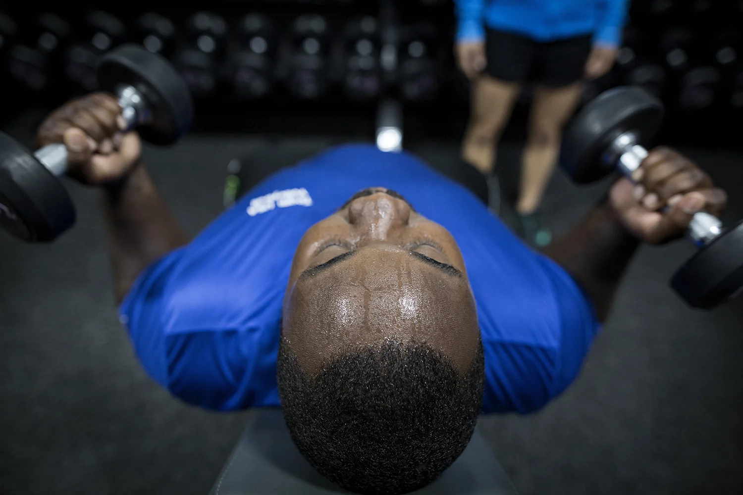 Grand Blanc, MI - Thursday, June 25, 2015: Athlete Michael Robinson from Grand Blanc, MI curls dumbbells during the team training session at Anytime Fitness in Grand Blanc, MI. The Michigan Special Olympics Volleyball Team has been preparing for the 2015 Special Olympics Summer Games in Los Angeles, CA beginning July 25. (Tim Galloway for ESPN)