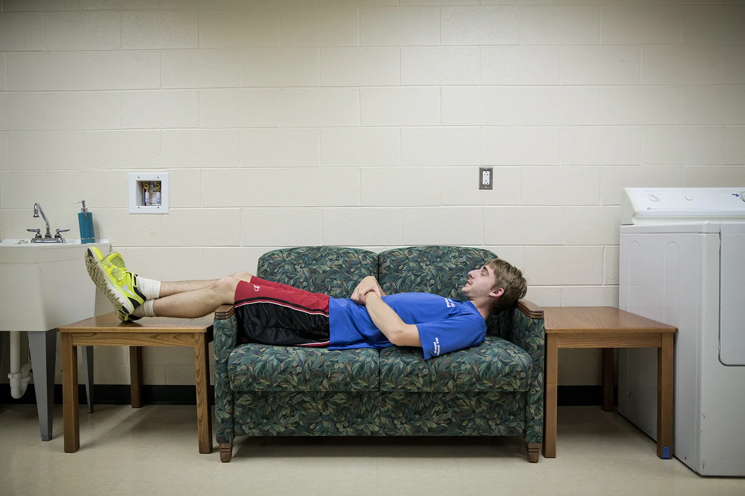 Flint, MI - Thursday, June 25, 2015: Athlete Drew Callahan from Clio, MI rests after dinner on a nearby couch at the Elmer A. Knopf Learning Center in Flint, MI. The Michigan Special Olympics Volleyball Team has been preparing for the 2015 Special Olympics Summer Games in Los Angeles, CA beginning July 25. (Tim Galloway for ESPN)