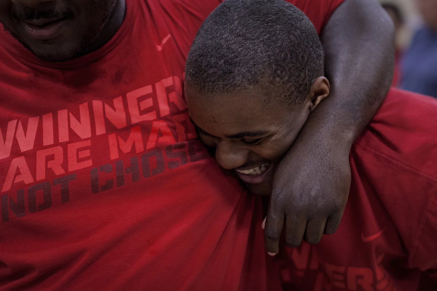 Flint, MI - Thursday, June 25, 2015: Dalvin Keller, center, from Flint, MI smiles as Michael Robinson from Grand Blanc, MI puts his arm around his during practice at the Elmer A. Knopf Learning Center in Flint, MI. The Michigan Special Olympics Volleyball Team has been preparing for the 2015 Special Olympics Summer Games in Los Angeles, CA beginning July 25. (Tim Galloway for ESPN)