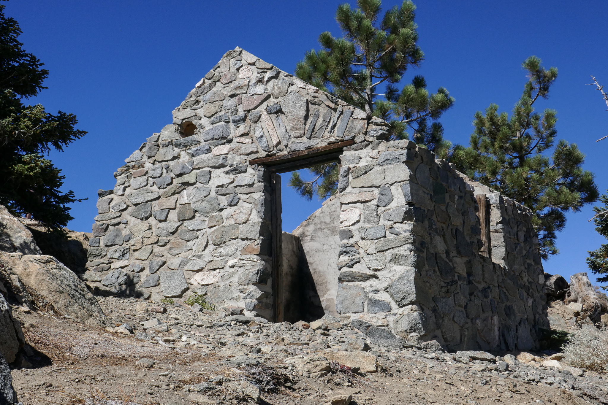 As we turn the corner of the last switchback, the old fire lookout appears. We are just a few feet from the top.