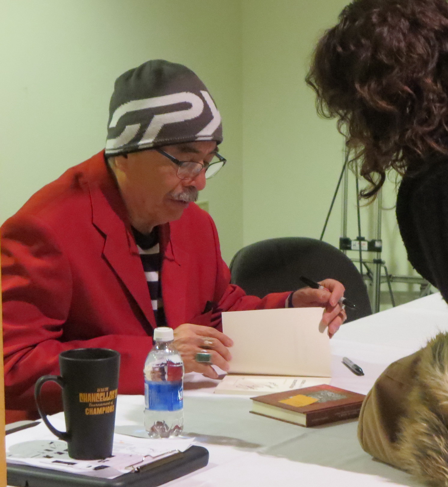 Juan Felipe Herrera, current Poet Laureate of the United States, signing book in Wisconsin.