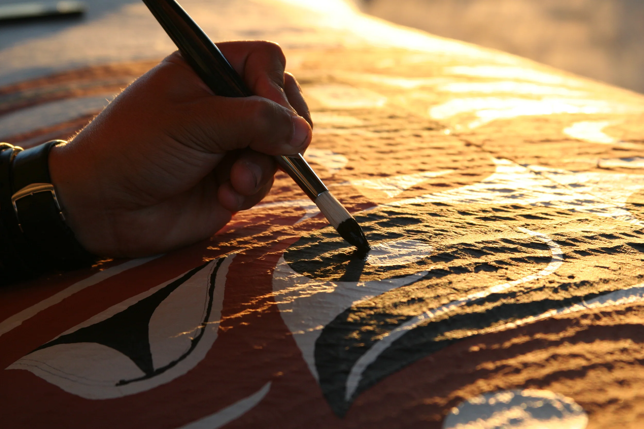 Painting the Thunderbird (detail) at sunset