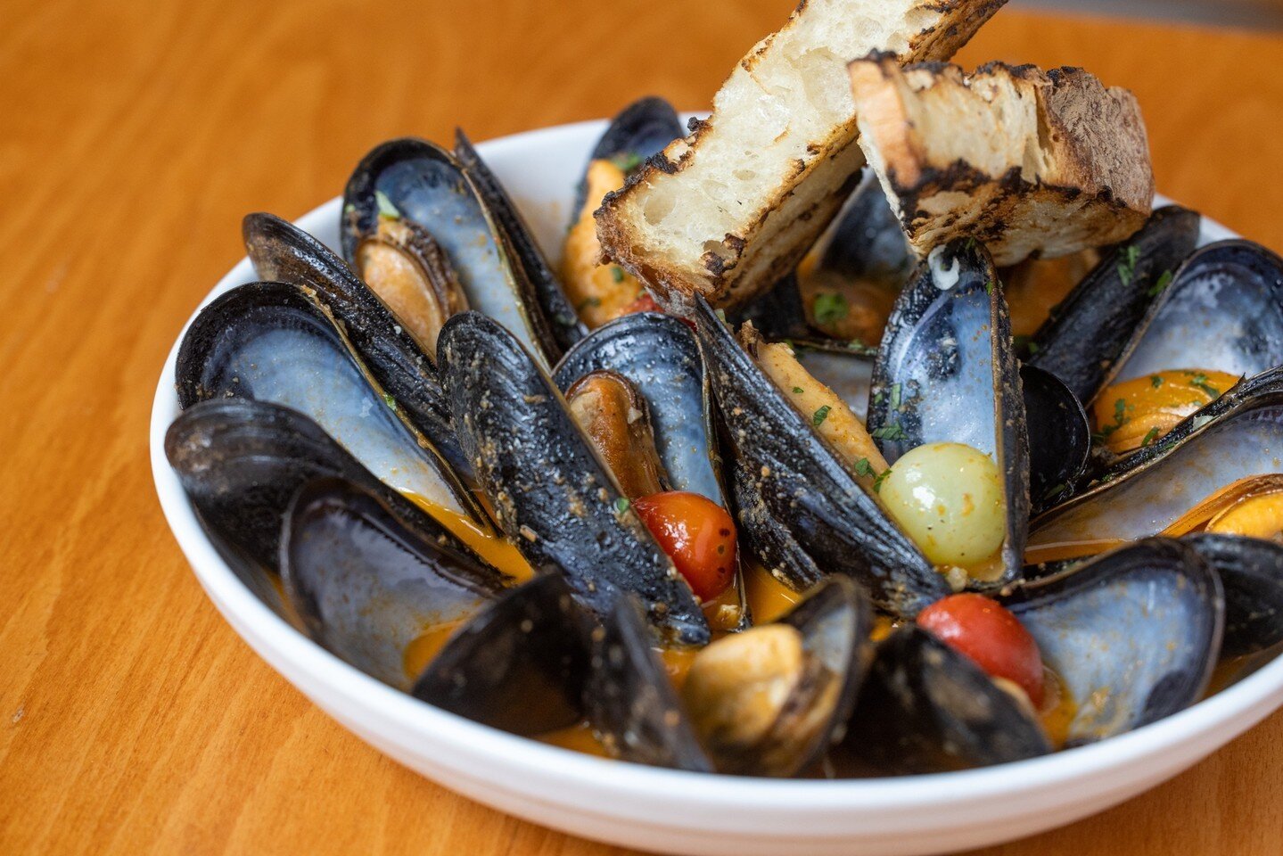 Looking for a new Maine squeeze?⁠
⁠
Our Maine Mussels are beautifully steamed with Cherry Tomatoes, White Wine, Green Onion, and Grilled Rustica Bread.⁠ ⁠
⁠
Pair this dish with a glass of one of our Italian Pinot Grigio for a coastal vacation without