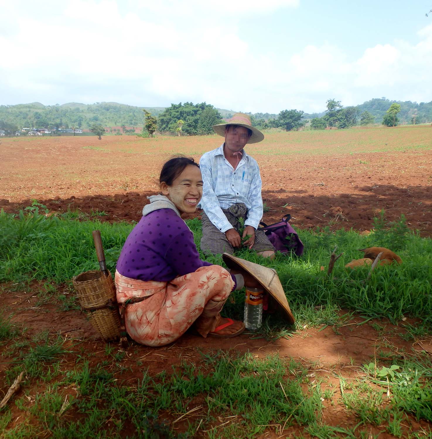 William stops to talk with a woman working in a field. 