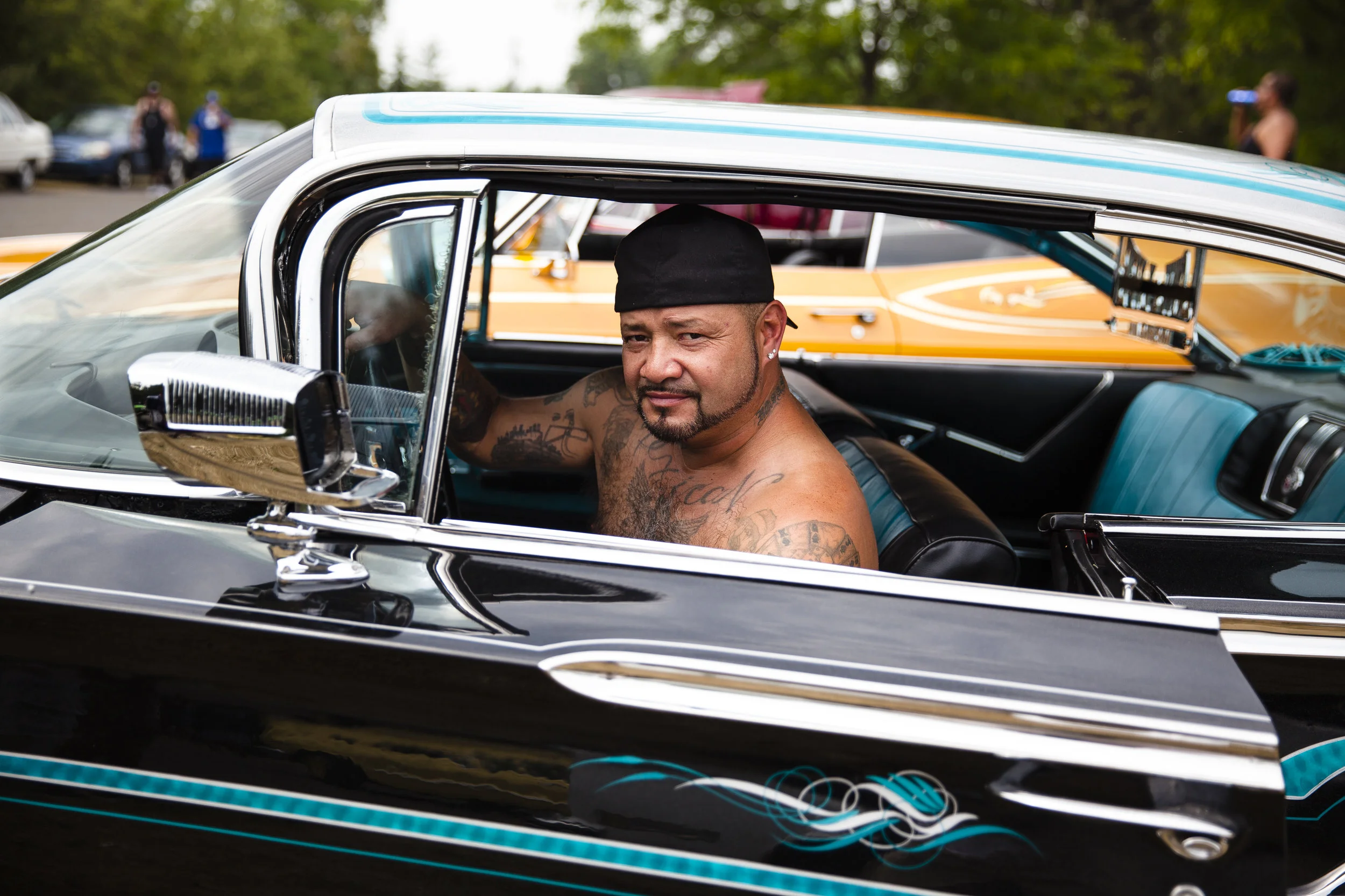 Toyo of Low 4 Life Car Club behind the wheel of his 60 Impala at Uso Detroit chapter’s annual picnic. Mariners Park, Detroit. (2016)