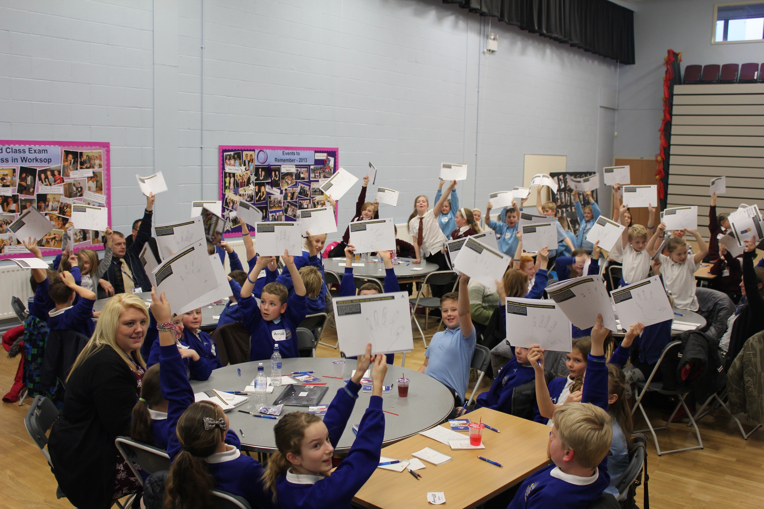 All holding up workbooks.jpg