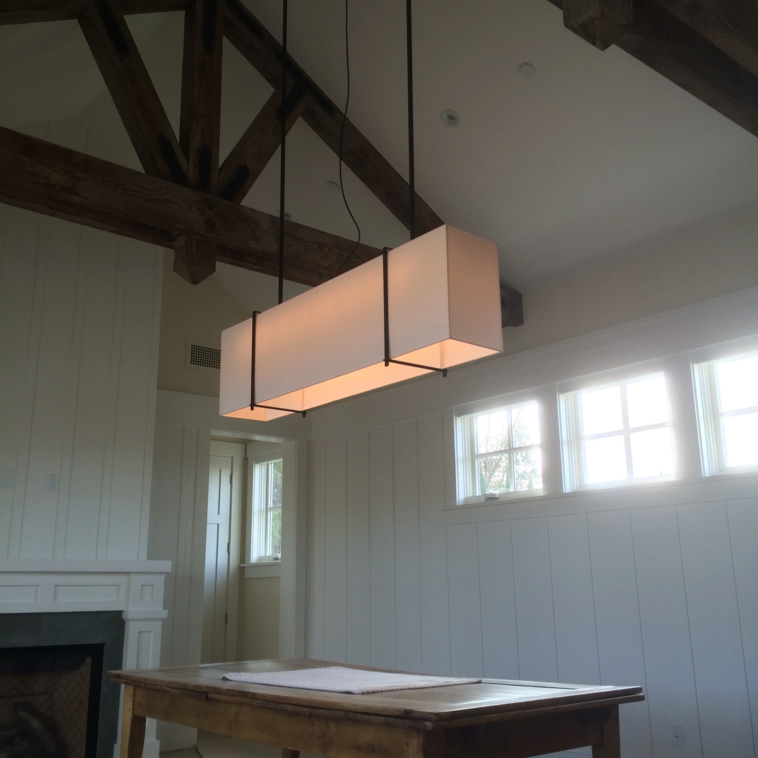 Helena 60 x 10 x16 pendant in white parchment and blackened steel/Nina Topper Interiors