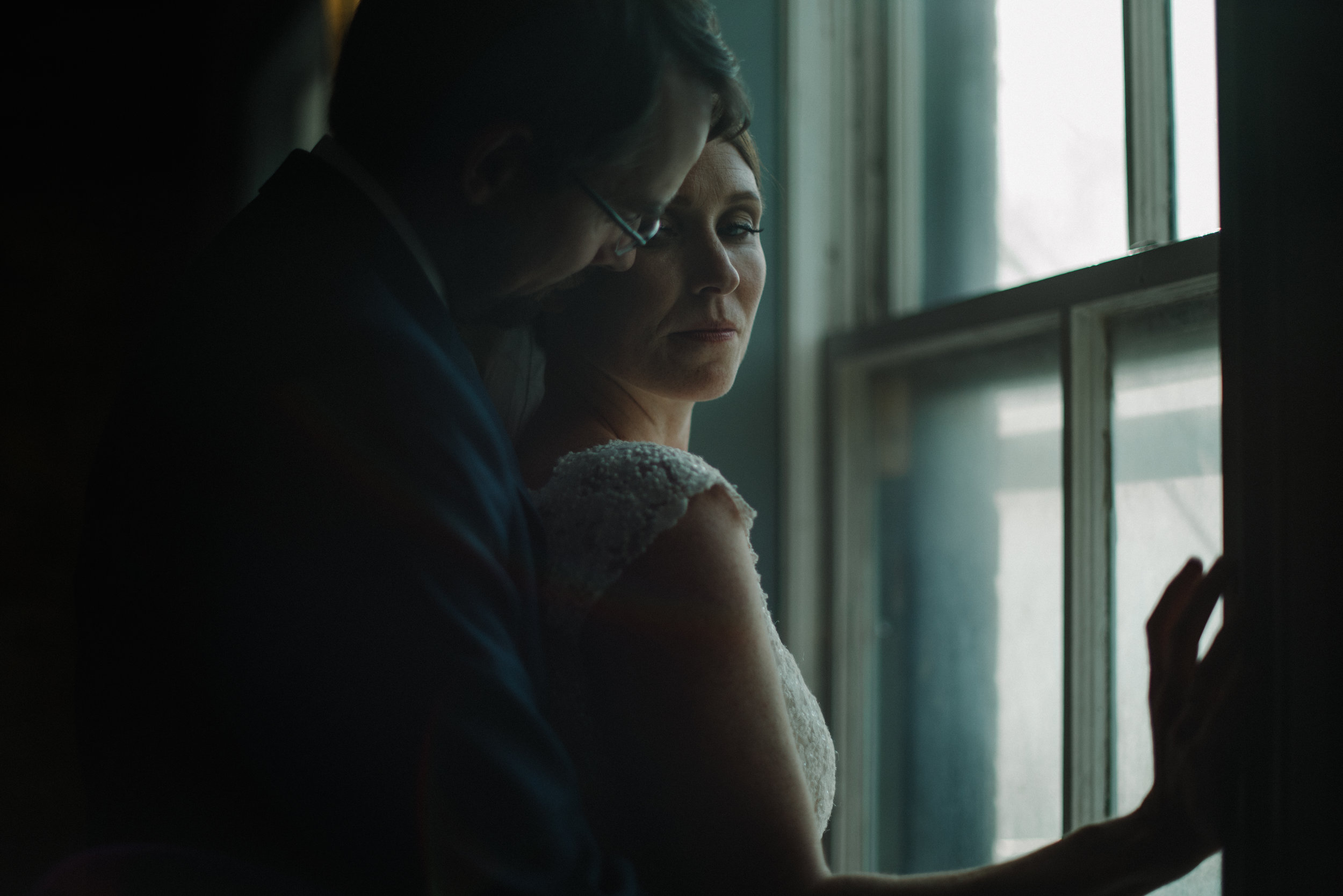 bride and groom in the window wedding photography.jpg