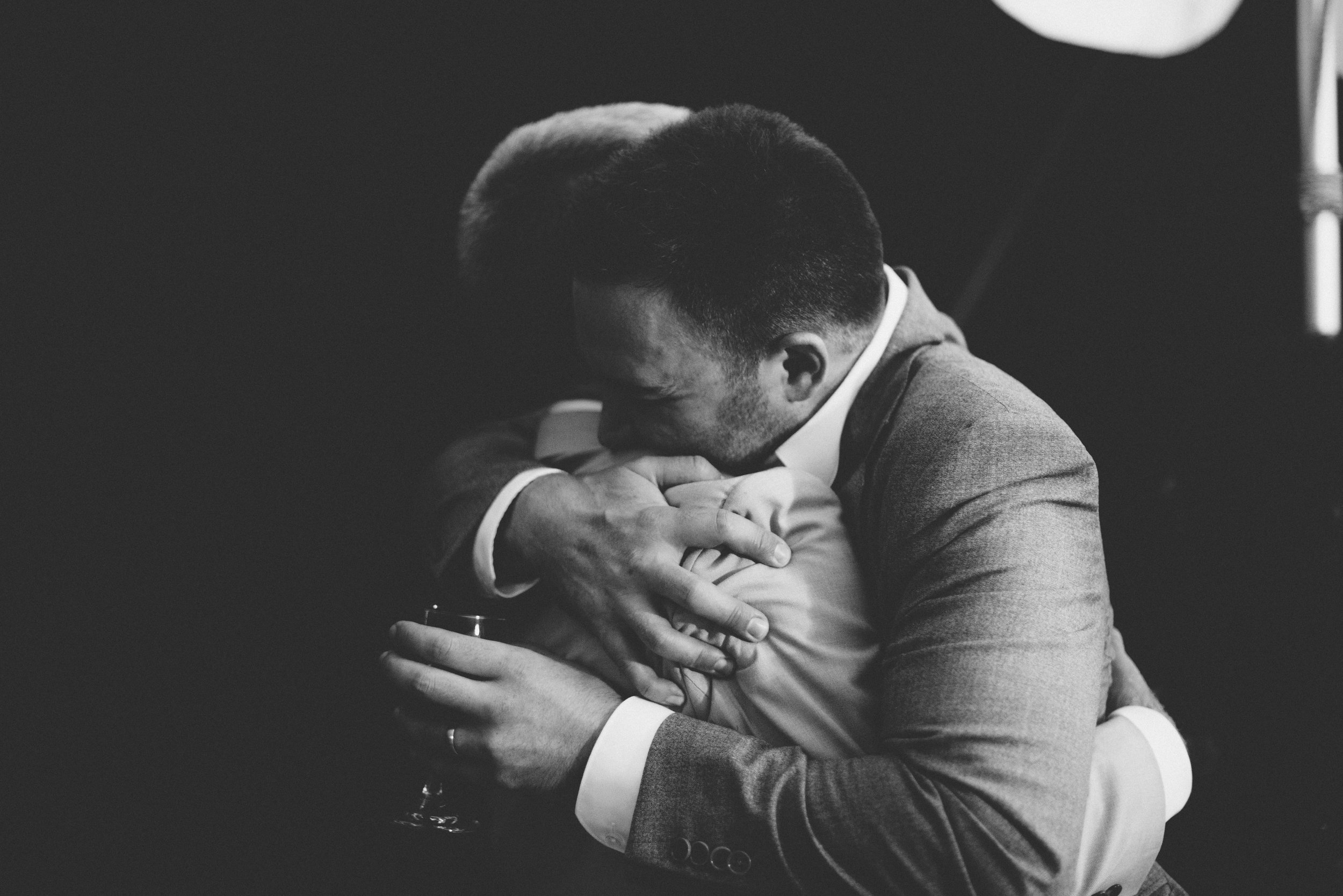 groom and dad hugging wedding photography.jpg