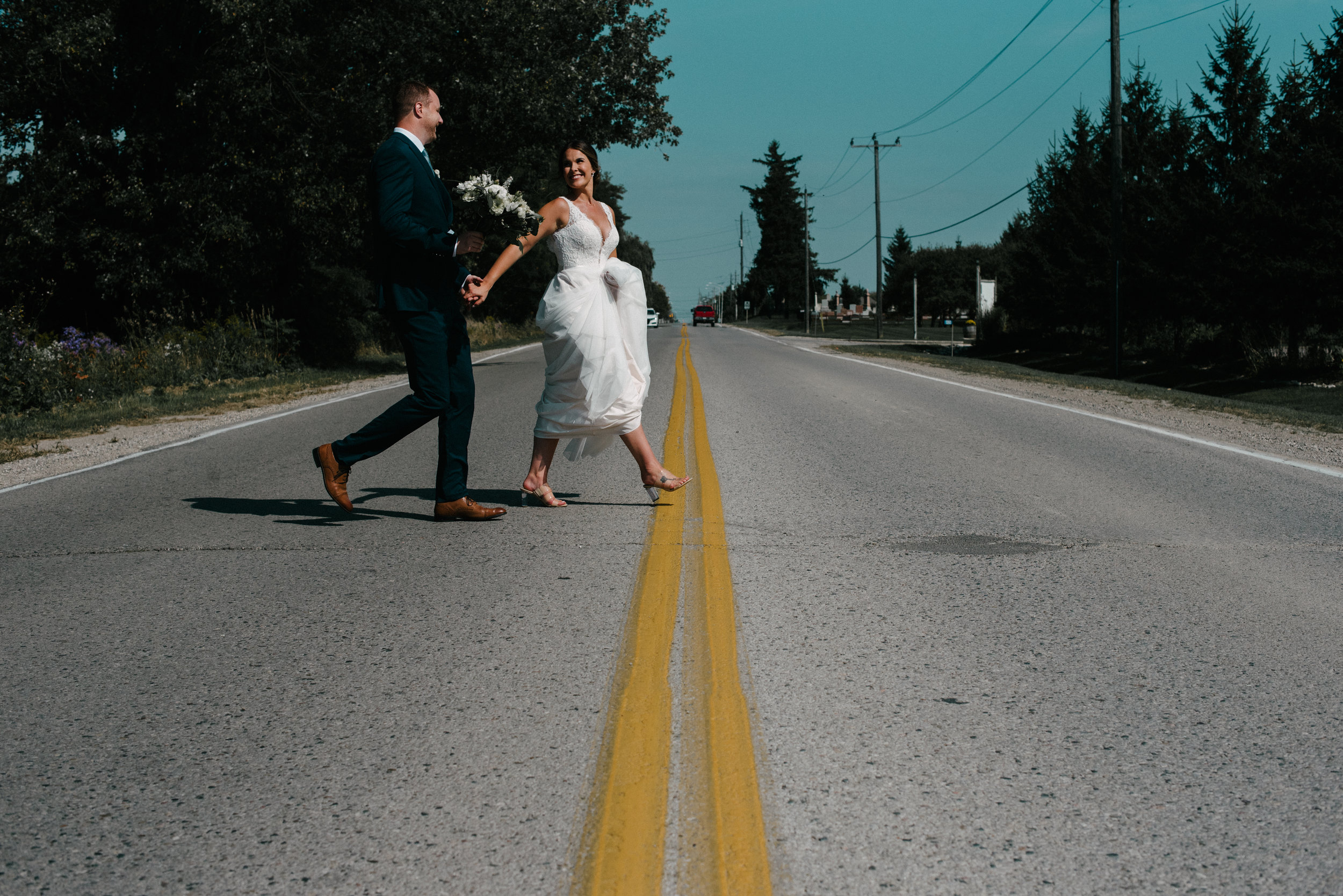 bride and groom crossing the street.jpg