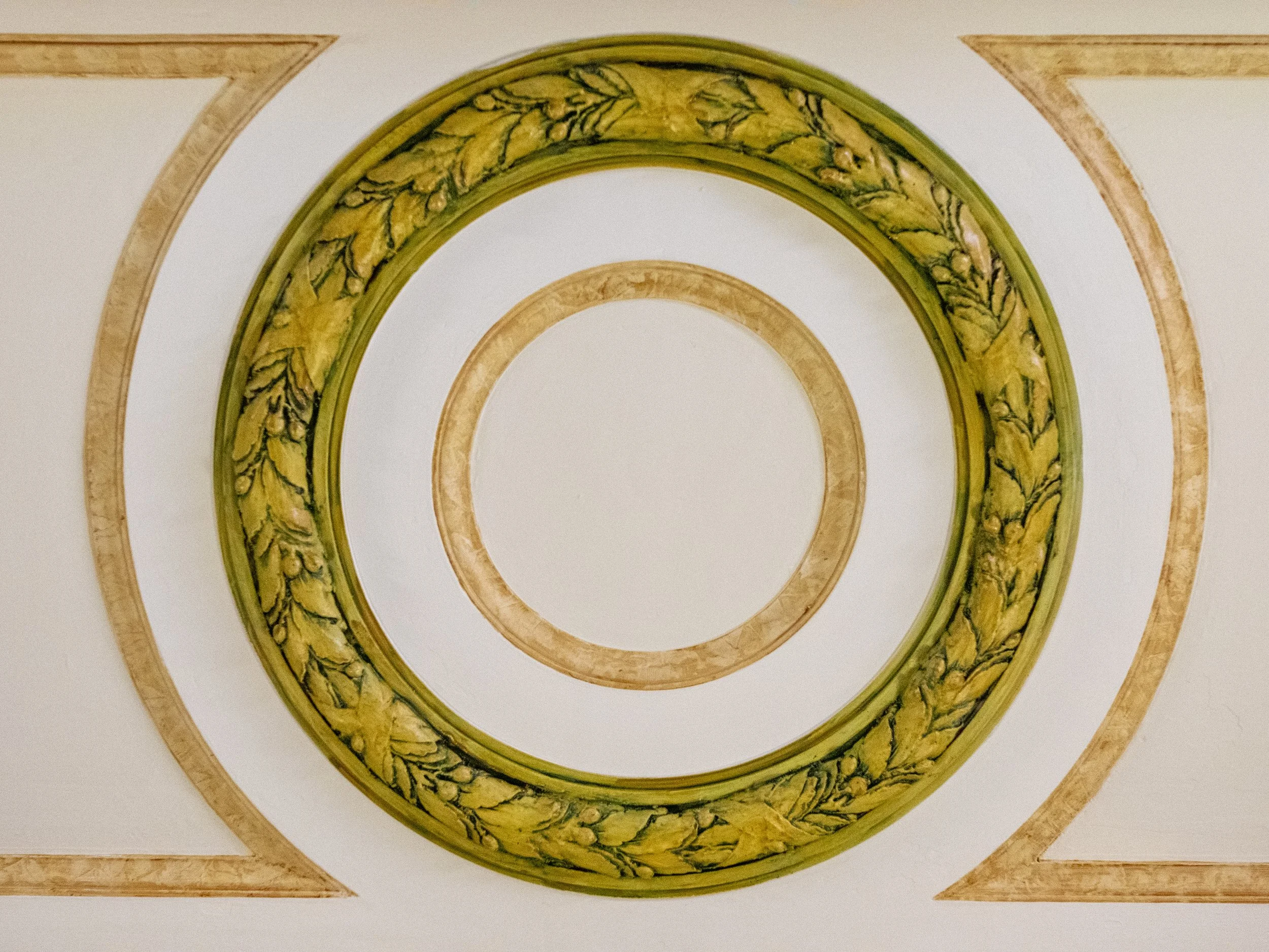 Plaster and enamel details use a gold and green palette