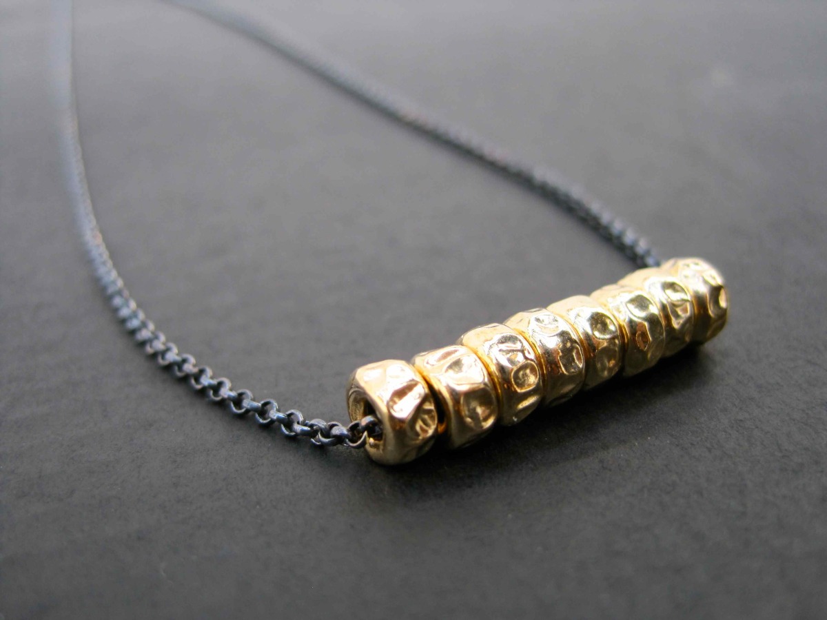 Gold Beads on a Black Chain