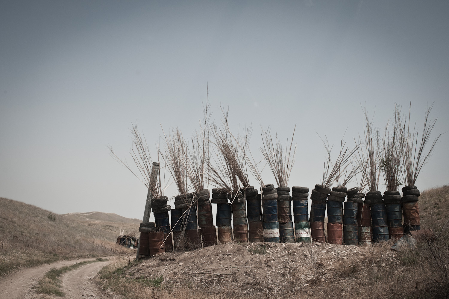  On the exposed portion of the road on the way to the Mataghis frontline is partially fortified against Azerbaijani gunfire by large metal canisters, tires and hay.  