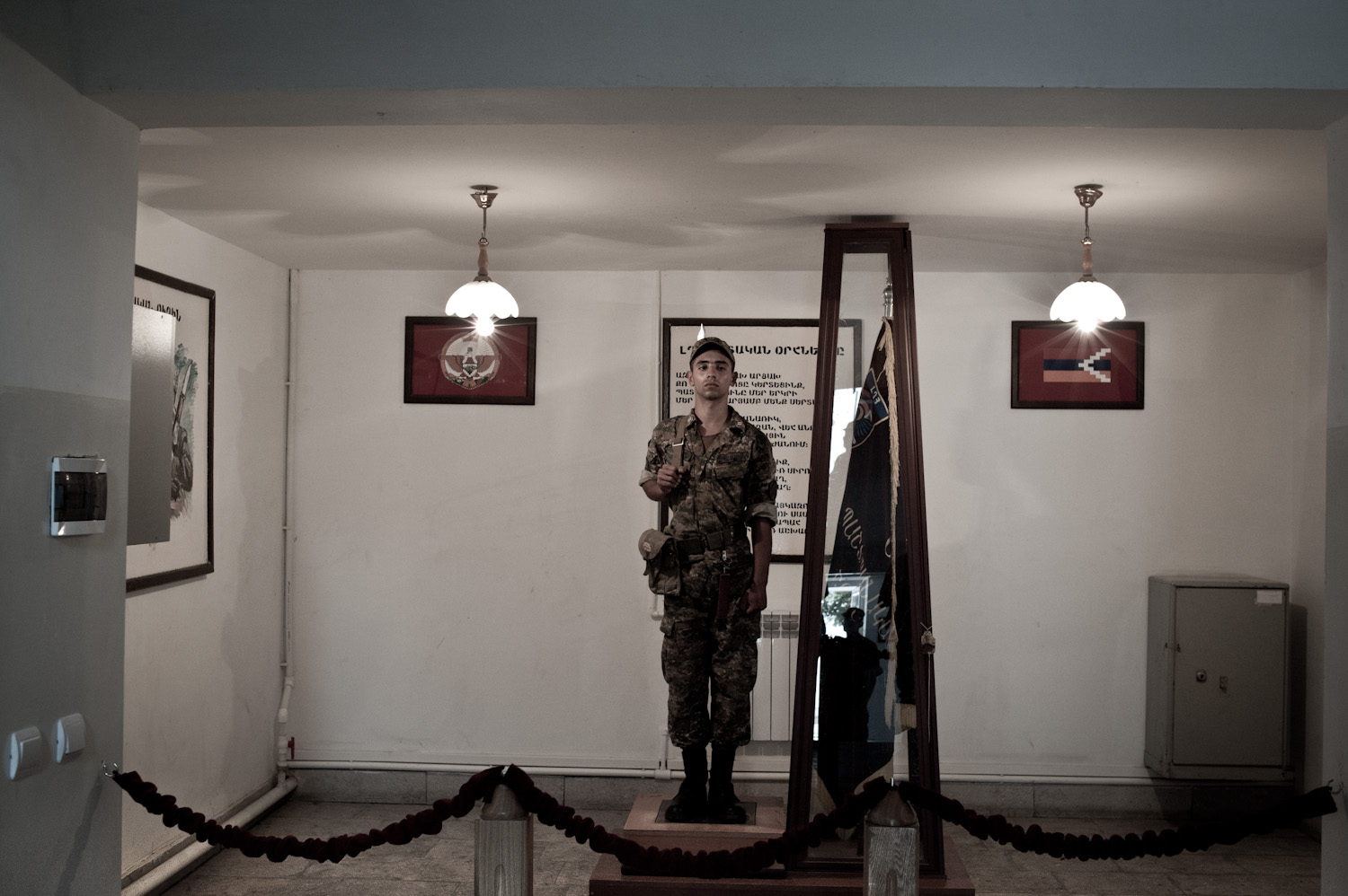  In two-hour shifts, a statuesque "honorary soldier" guards the flag of the Mataghis military unit at headquarters near Martakert, Nagorno-Karabakh.  