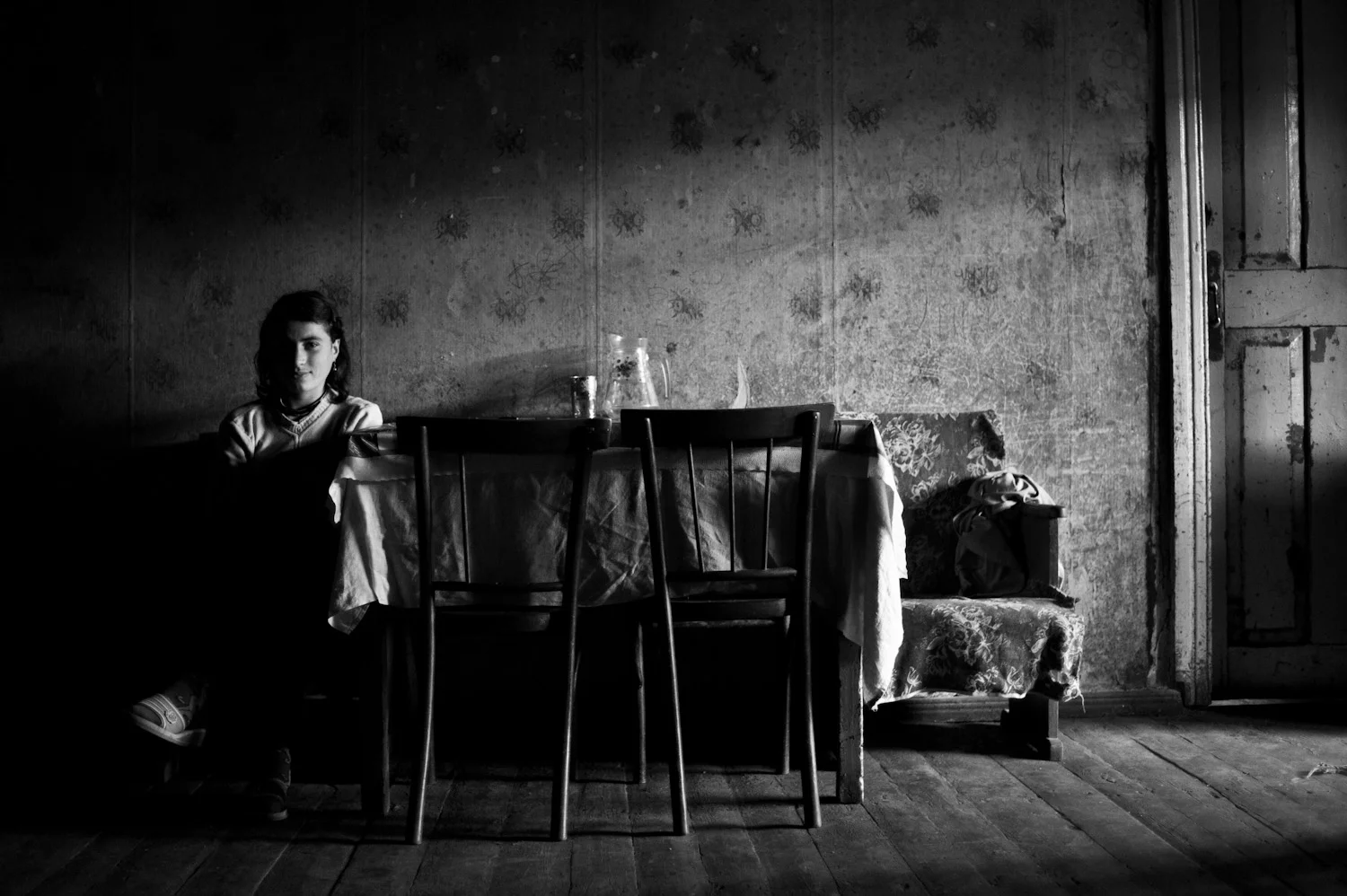 Lilit at home in Dastakert. Her father Roudik moved to Dastakert from Baku 23 years ago. To help her family get by, Lilit works in a neighbor's field picking berries and harvesting grass. Lilit's dream is to leave the small town and move to Armenia's capital Yerevan.