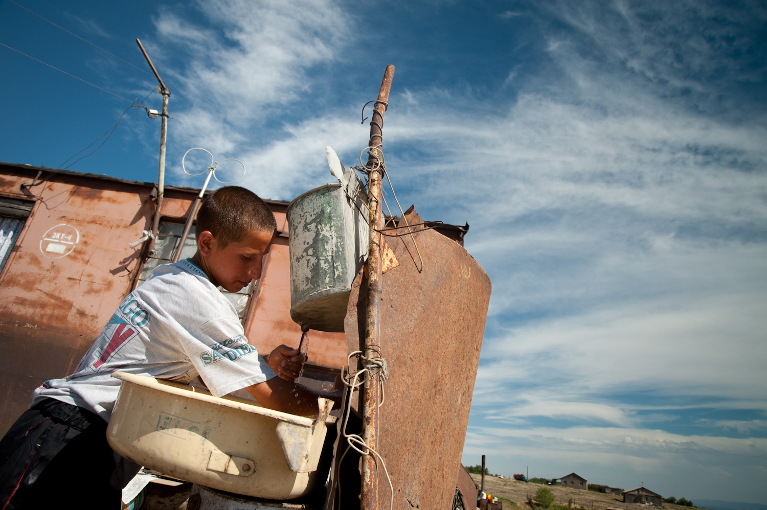 The nearest water source for Ruzana and her children is a one-hour roundtrip walk from their shack in Nubarashen. A journey the four children take turns making daily.