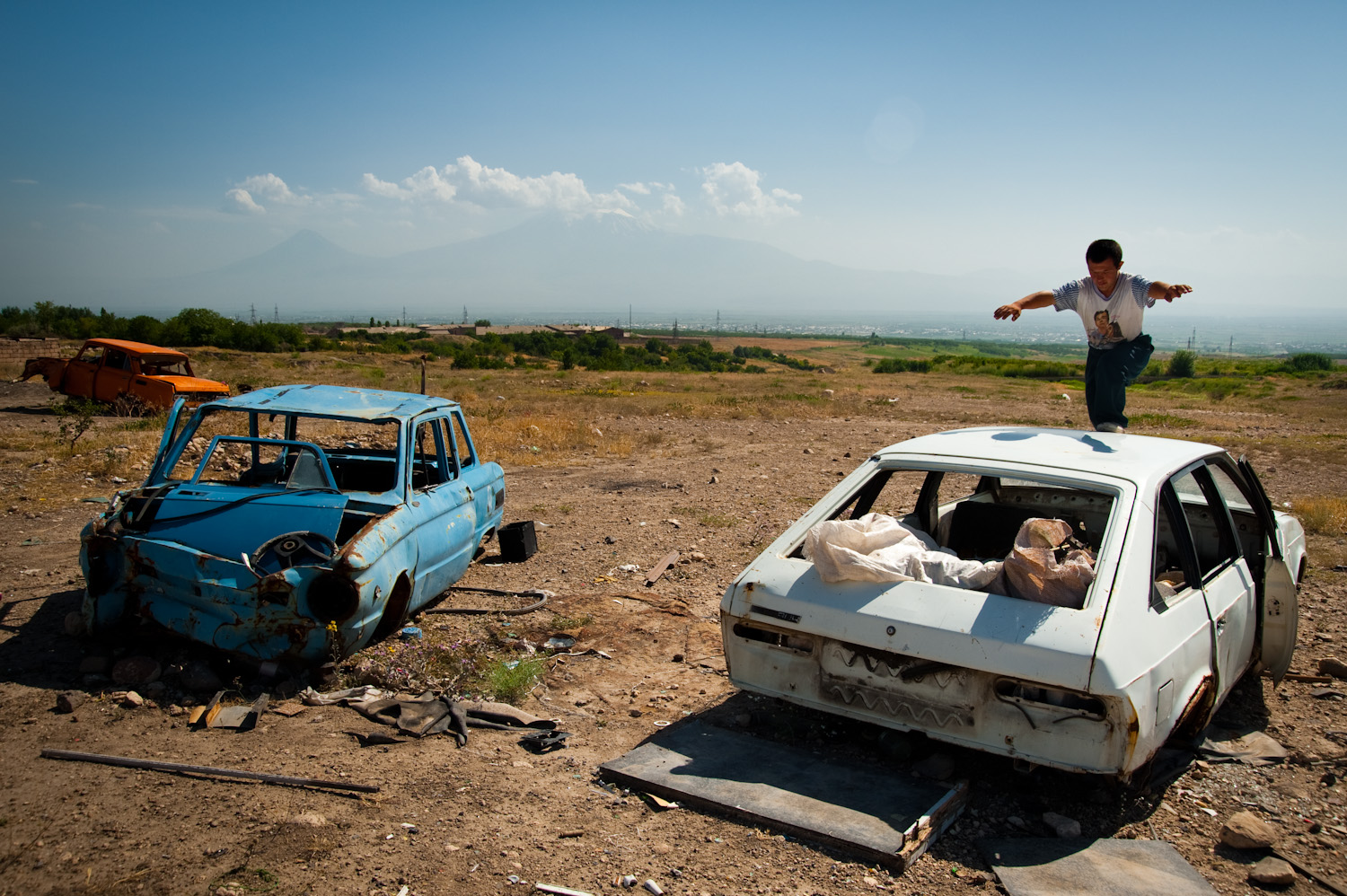  Discarded cars near his shack are Nver's playground. He is Ruzana's eldest and was born with down syndrome. Children with disabilities are often given to orphanages in Armenia. Despite their difficult life, Ruzana chose to keep Nver.  
