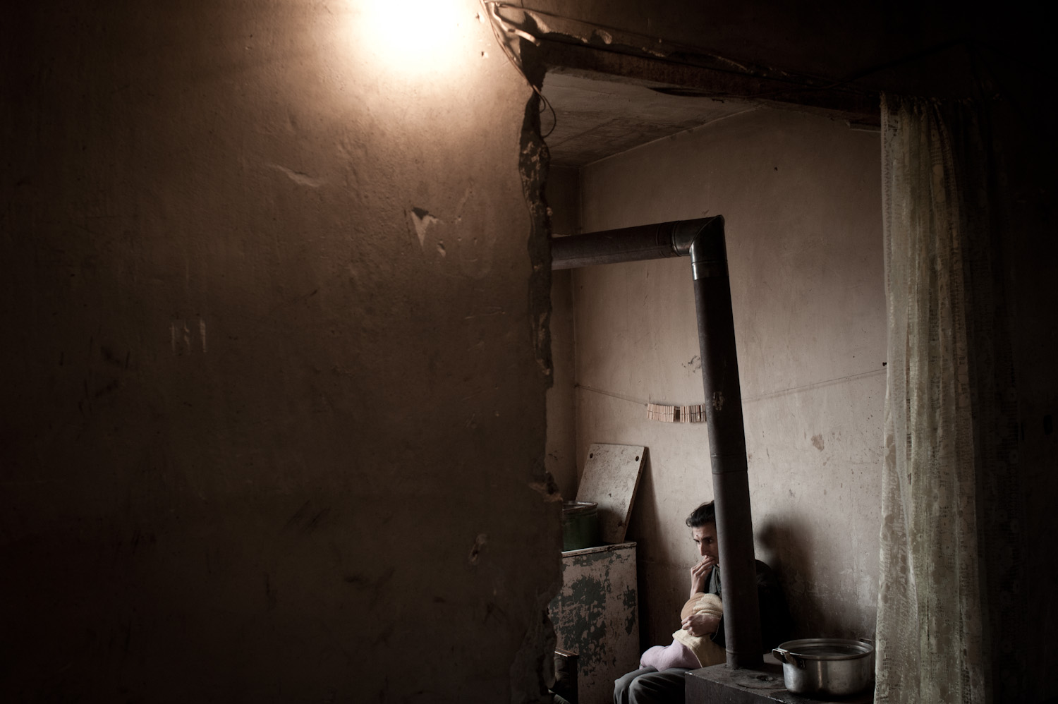 Jora's mother Gohar breastfeeding her youngest child. Jora was her eldest. She has four children remaining - two of them boys, who upon their eighteenth birthday will in turn be required to serve in the military.