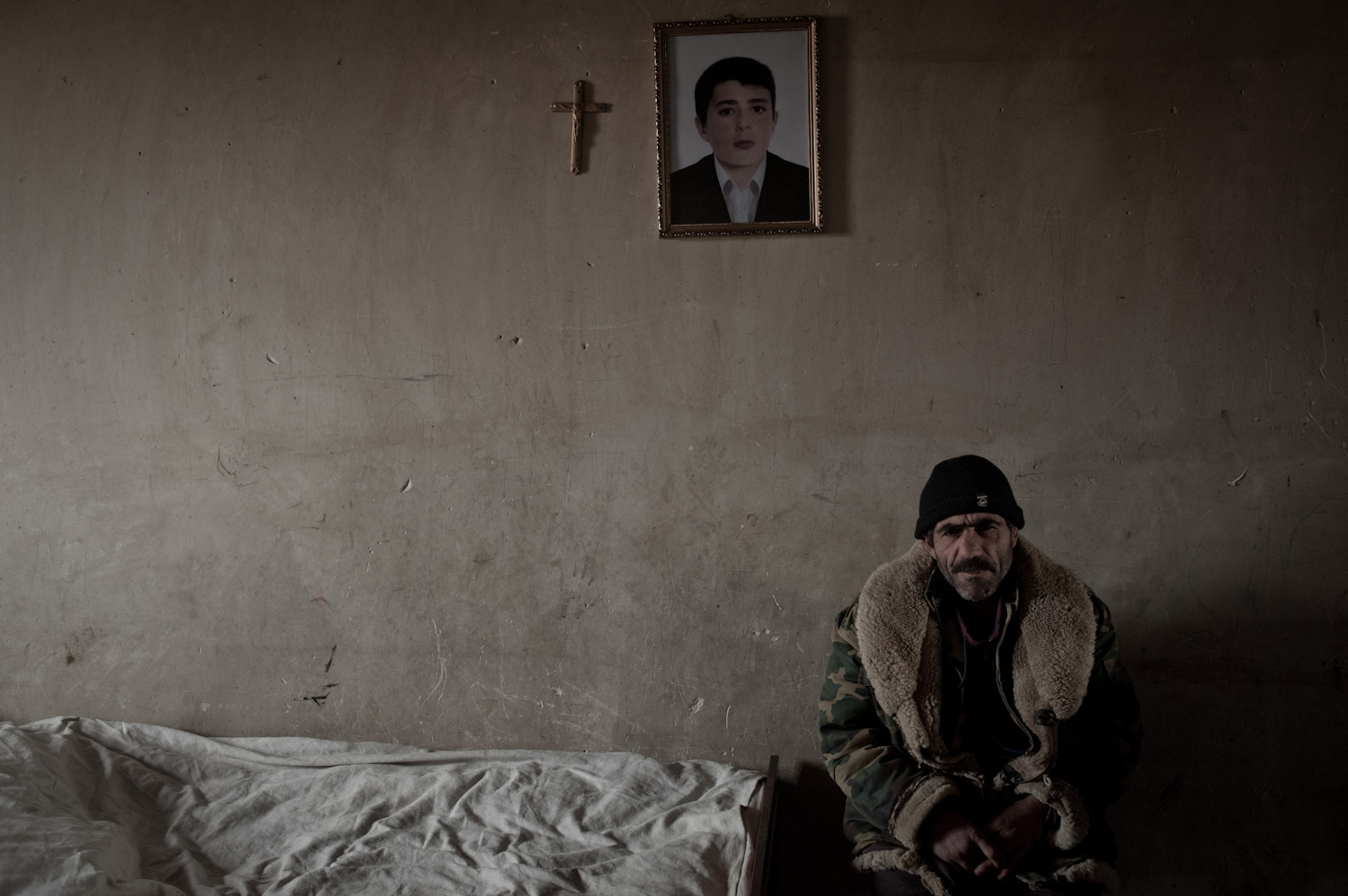  Meguerdich Meguerdichian sits next to the bed where his son Jora died in 2012. While serving at the Yeghnikner military base, Jora was severely beaten and fell into a coma. He later died at home in Lousakn village.   