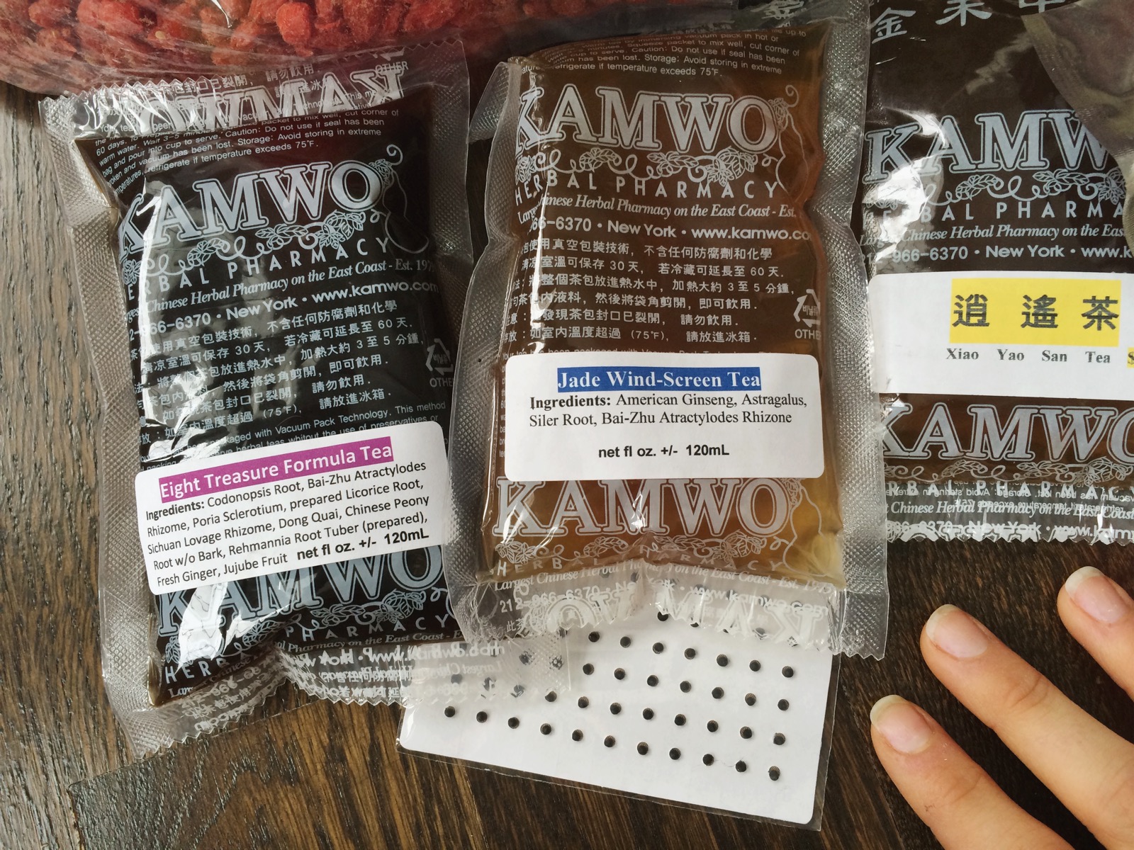 Patented formulas that are pre-brewed and vacuum sealed. The paper with the dots are acupuncture ear seeds!