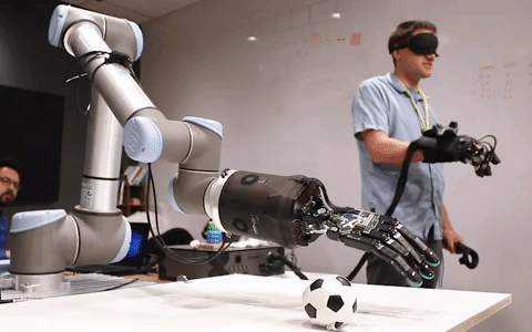 Michael Eichermueller, Director of Research and Development at HaptX, controls the haptic telerobot system while wearing a blindfold. Though he cannot see what he’s doing, his sense of touch enables him to grasp and pick up the toy soccer ball.