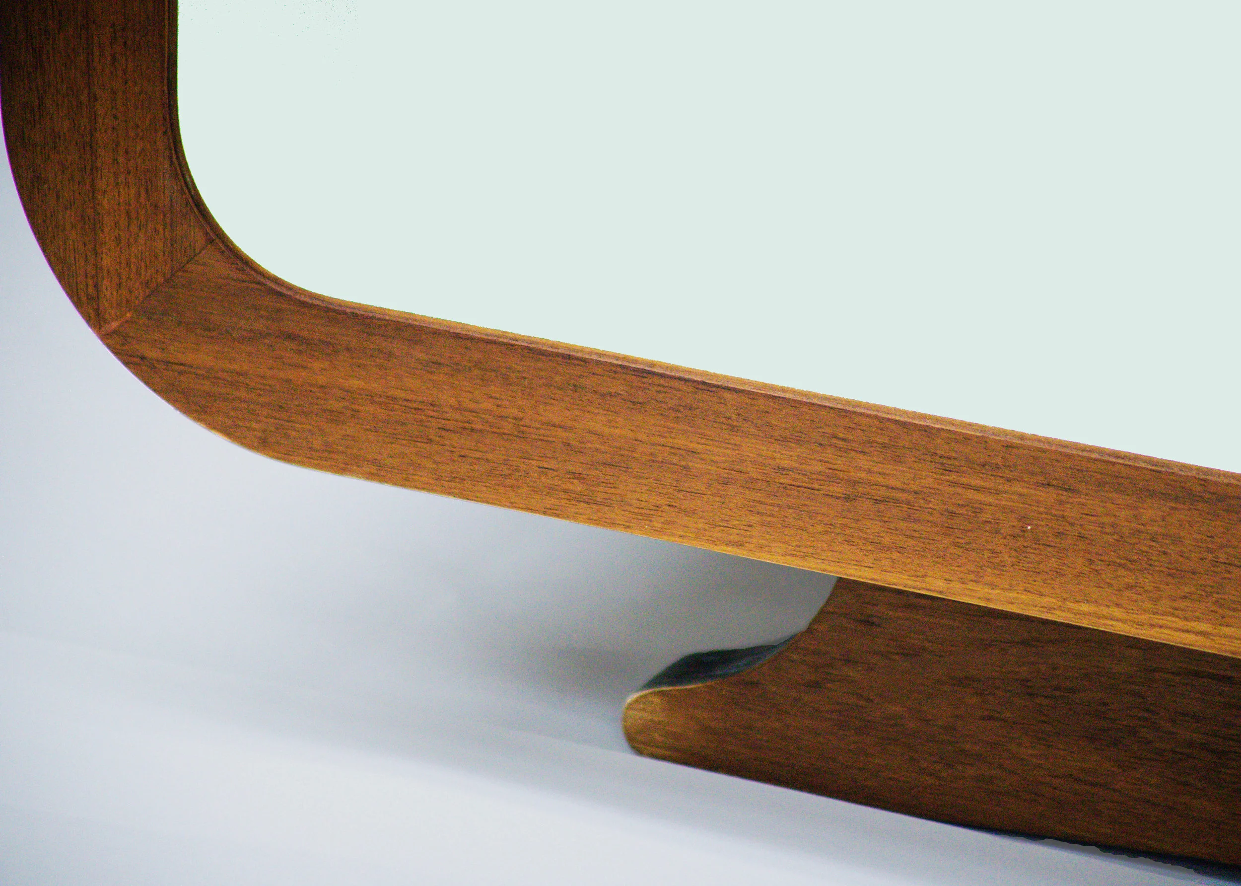 Oval Teak and laminate coffee table. the piece is 27” wdeep and a little over 72” long. Built in conjunction with 12’th Street Design