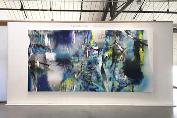 Artist Chris Trueman's art hangs in a contemporary gallery.