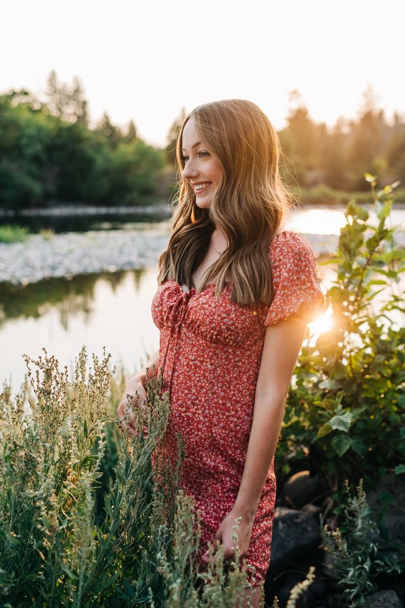 HS senior in red dress near river.jpg