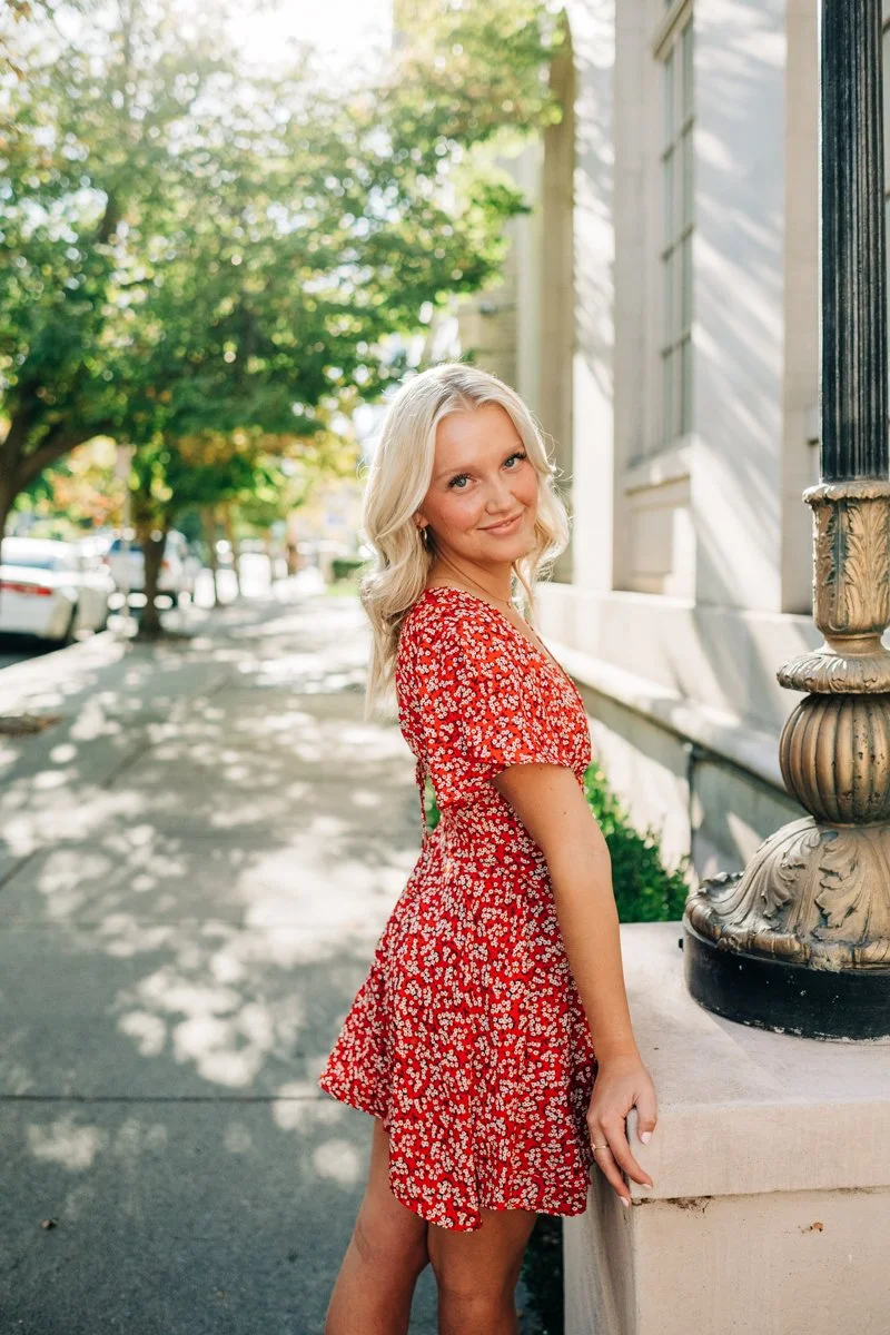 senior in red dress downtown.jpg