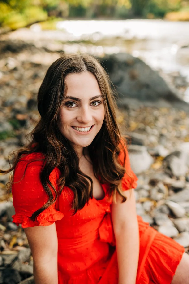 senior in red dress near river.jpg