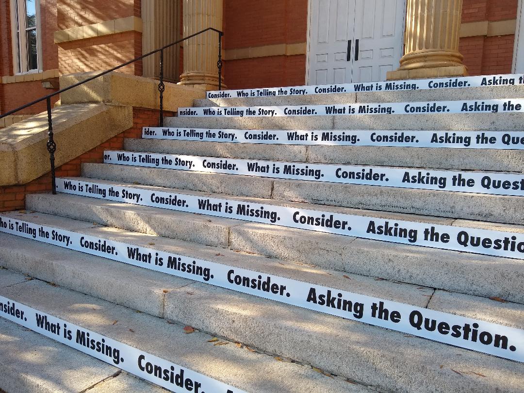 Consider , 2018 (detail) Site-specific black and white vinyl text, 14 concrete stairs (Winthrop University/The Rutledge Stairs) Consider is a site-specific vinyl text piece that invites viewers to think critically about what they see. Strips of black and white vinyl text have been attached to alternating risers allowing for a full reading and interaction.