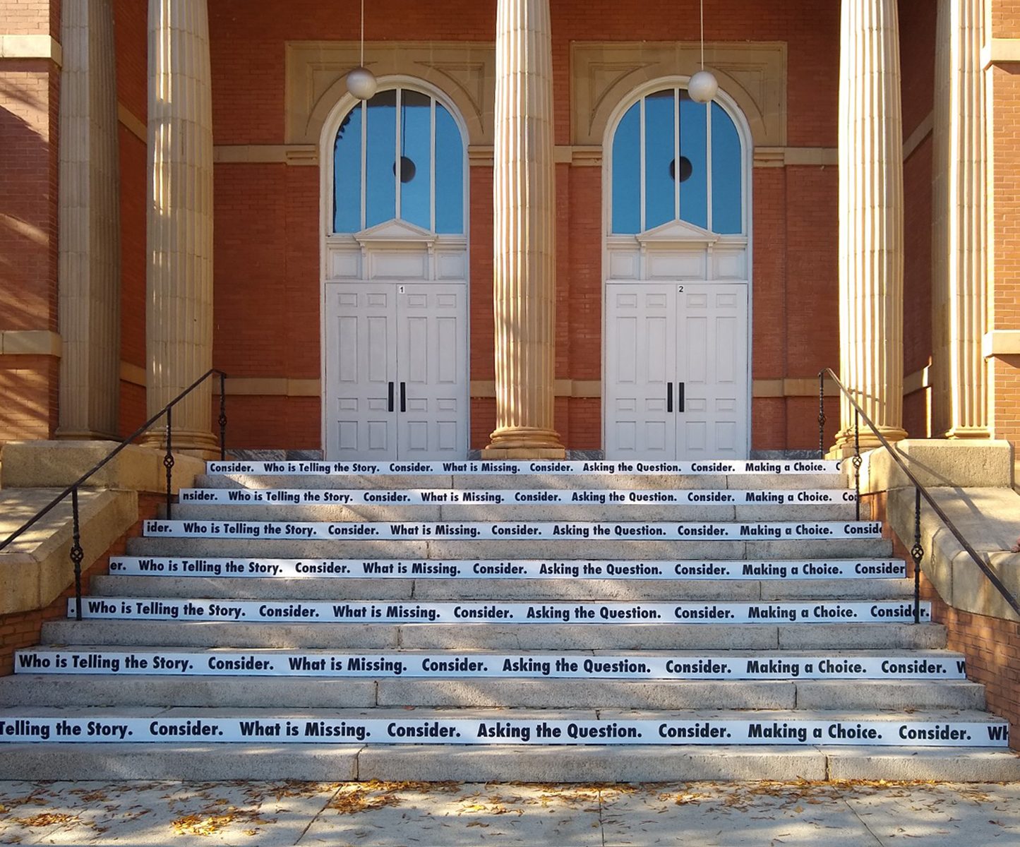   Consider , 2018  Site-specific black and white vinyl text, 14 concrete stairs (Winthrop University/The Rutledge Stairs)   Consider  is a site-specific vinyl text piece that invites viewers to think critically about what they see.  Strips of black a