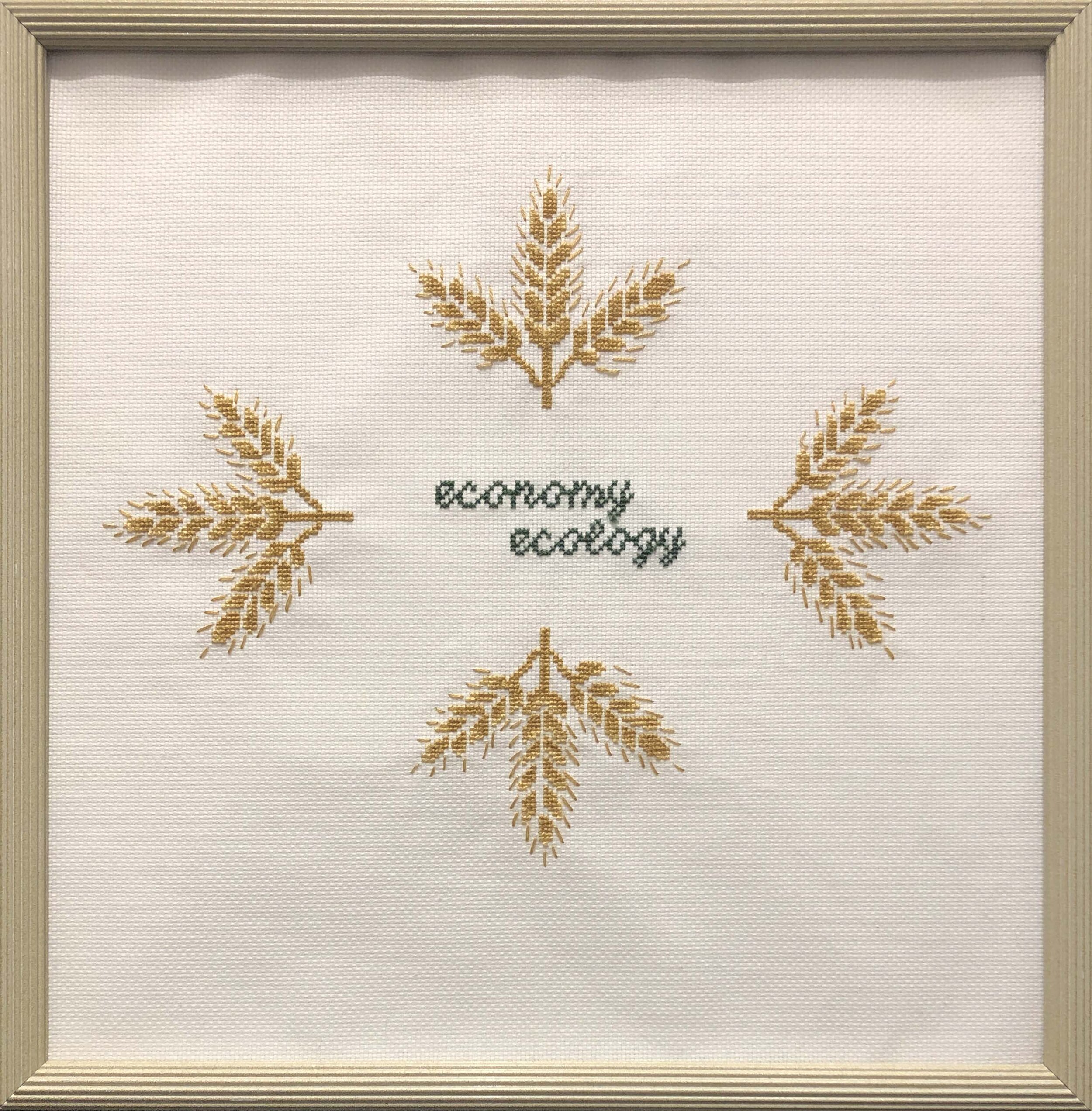   Economy Over Ecology , embroidery floss on Aida cloth, vintage frame, 14” x 16”, 2014 