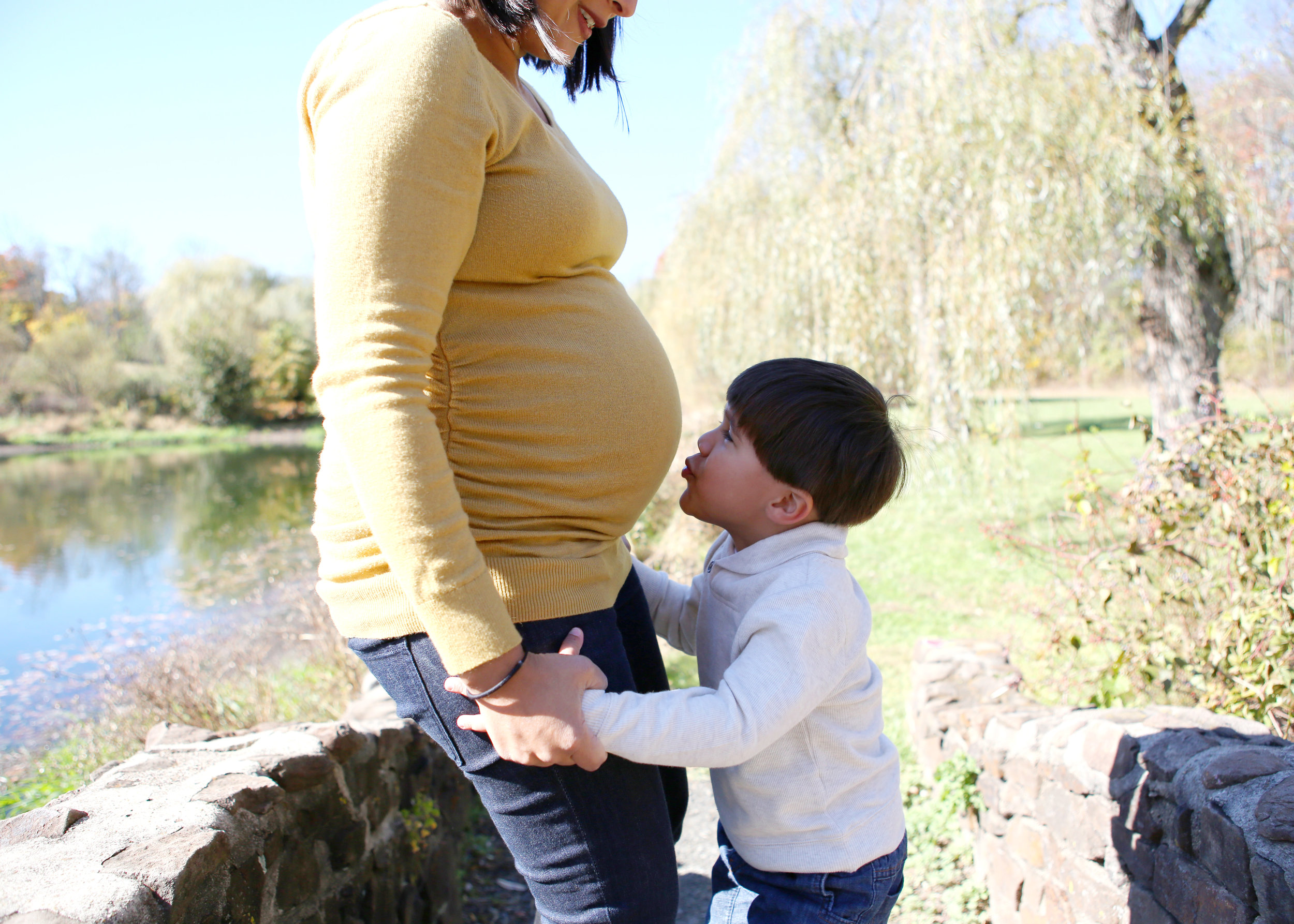 NJ and NYC based lifestyle photographer | Jennifer Lavelle Photography |  children and families, newborn, lifestyle, interiors, food and travel.  Boy kissing mom's belly.