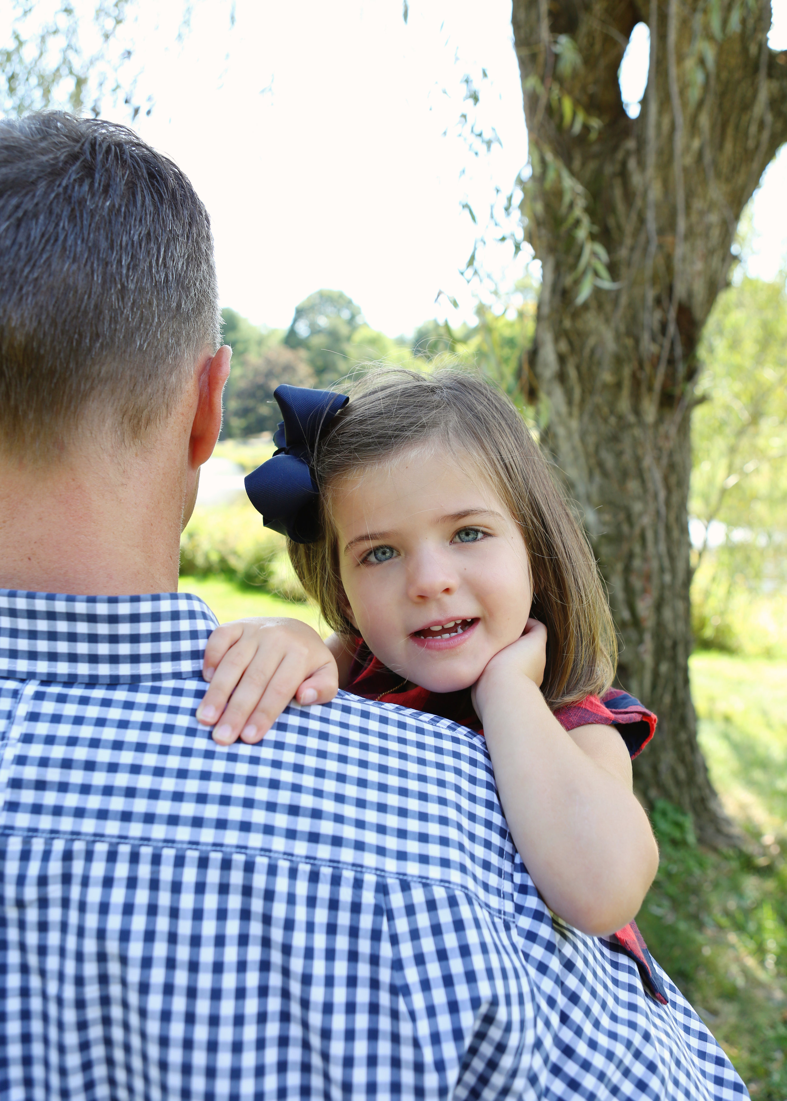 NJ and NYC based lifestyle photographer | Jennifer Lavelle Photography |  children and families, newborn, lifestyle, interiors, food and travel.  Little girl looking over dad's shoulder.