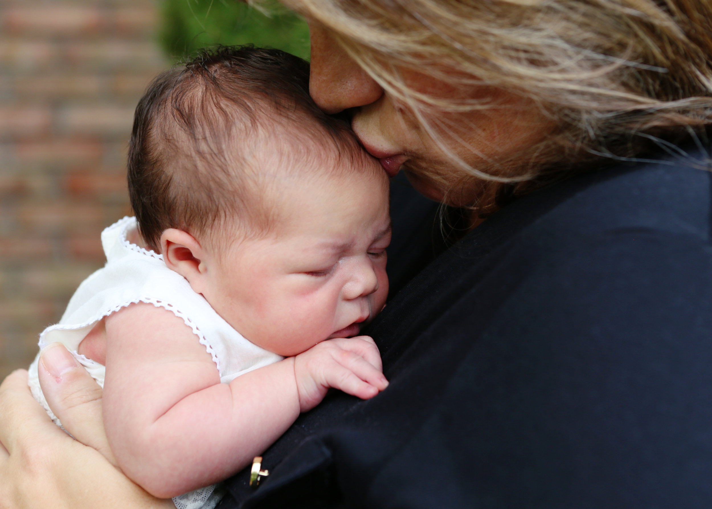 NJ and NYC based lifestyle photographer | Jennifer Lavelle Photography |  children and families, newborn, lifestyle, interiors, food and travel.  Newborn session with mom kissing baby's head.