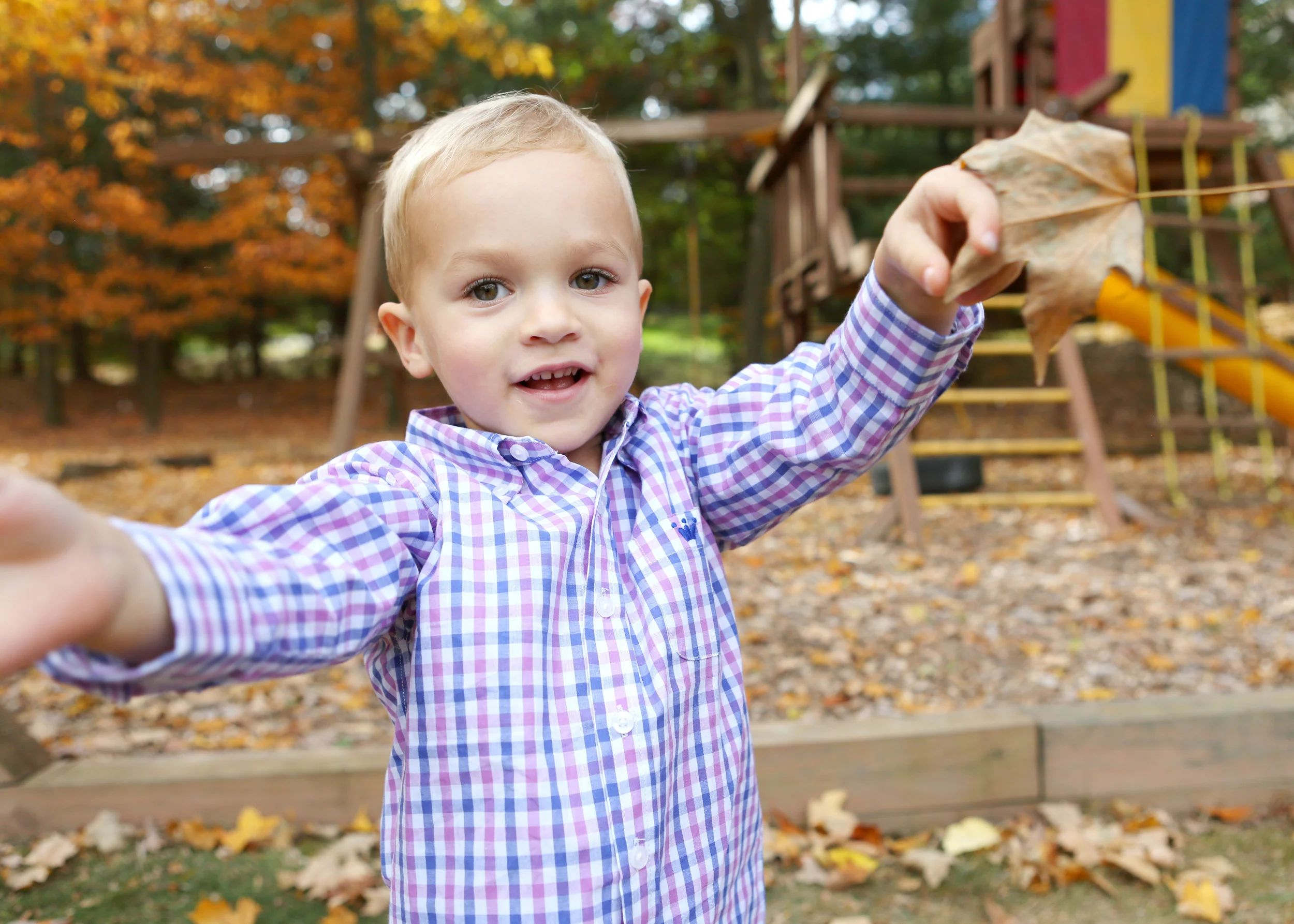 NJ and NYC based lifestyle photographer | Jennifer Lavelle Photography | children and families, newborn, lifestyle, interiors, food and travel. Big brother playing in leaves.