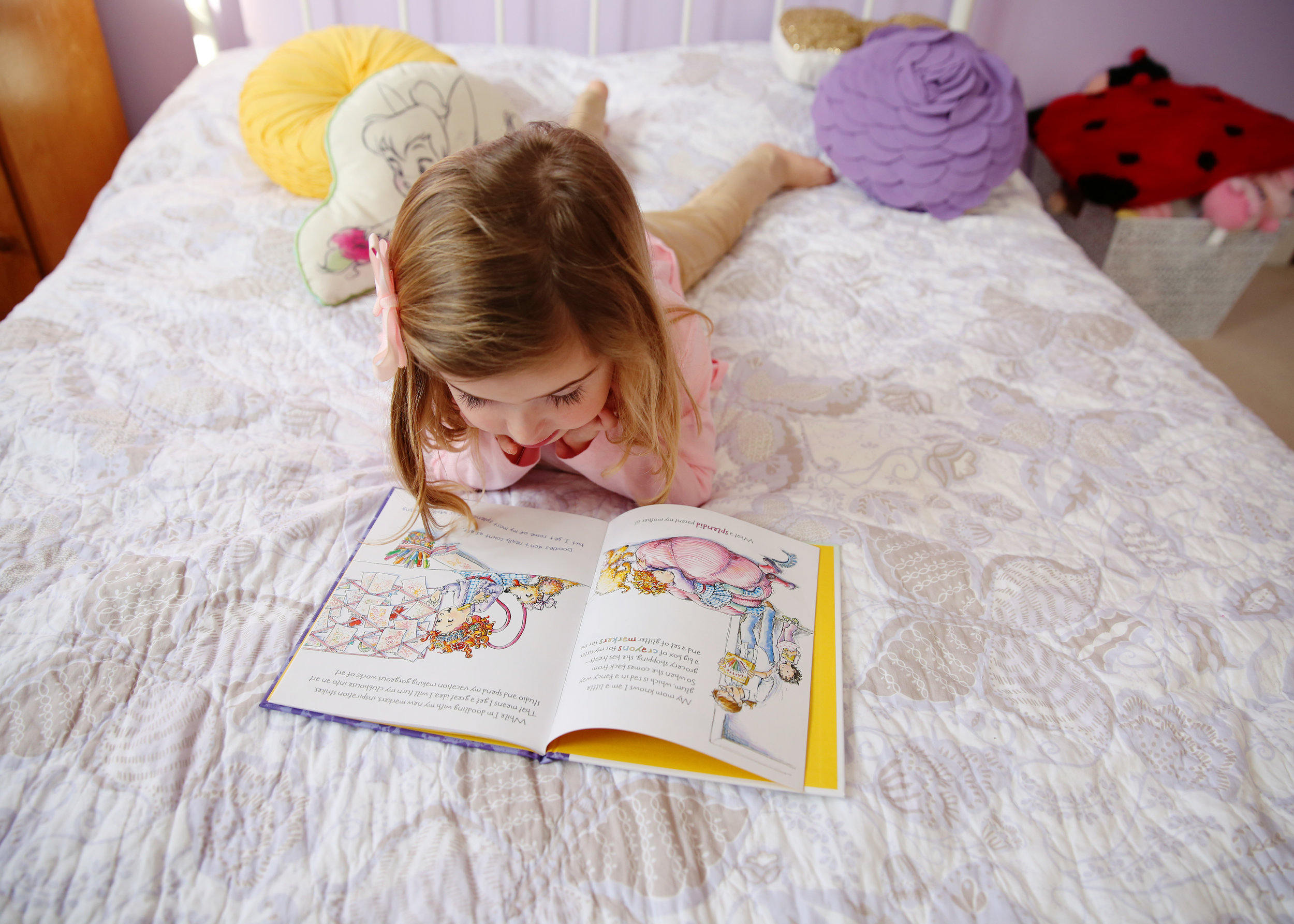 Chatham, NJ based lifestyle photographer Jennifer Lavelle Photography -  newborn, children, family lifestyle photography  |  little girl reading on bed