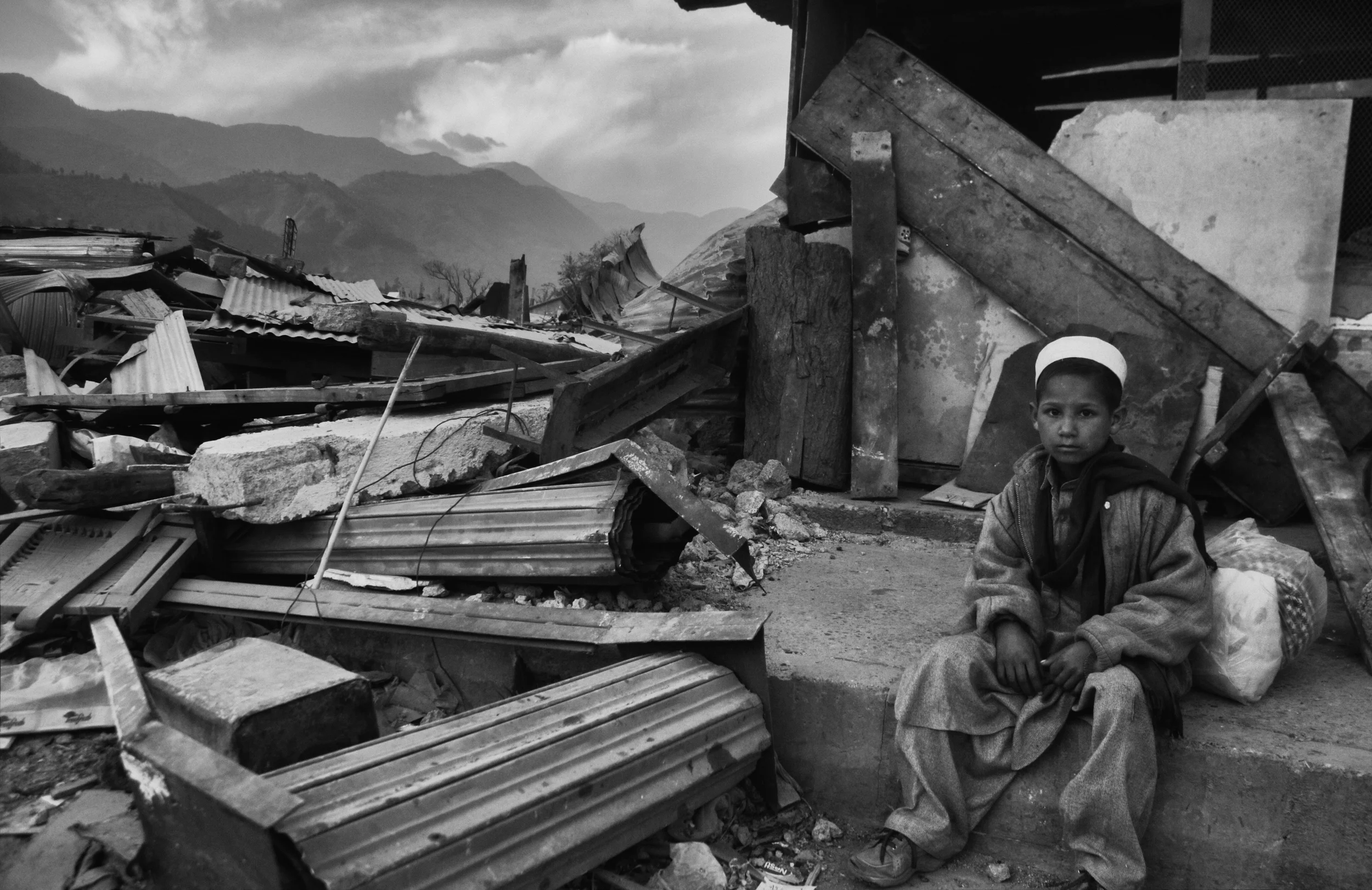 A young boy in the rubble during Eid al-Fitr in Balakot, NWFP, Pakistan, November 11, 2005. (Photo / Mark Pearson) The massive October earthquake in Kashmir affected one of the highest and most remote places on earth. Difficult terrain slowed the relief effort and the largest scale humanitarian air operations since the Berlin blockade began. 