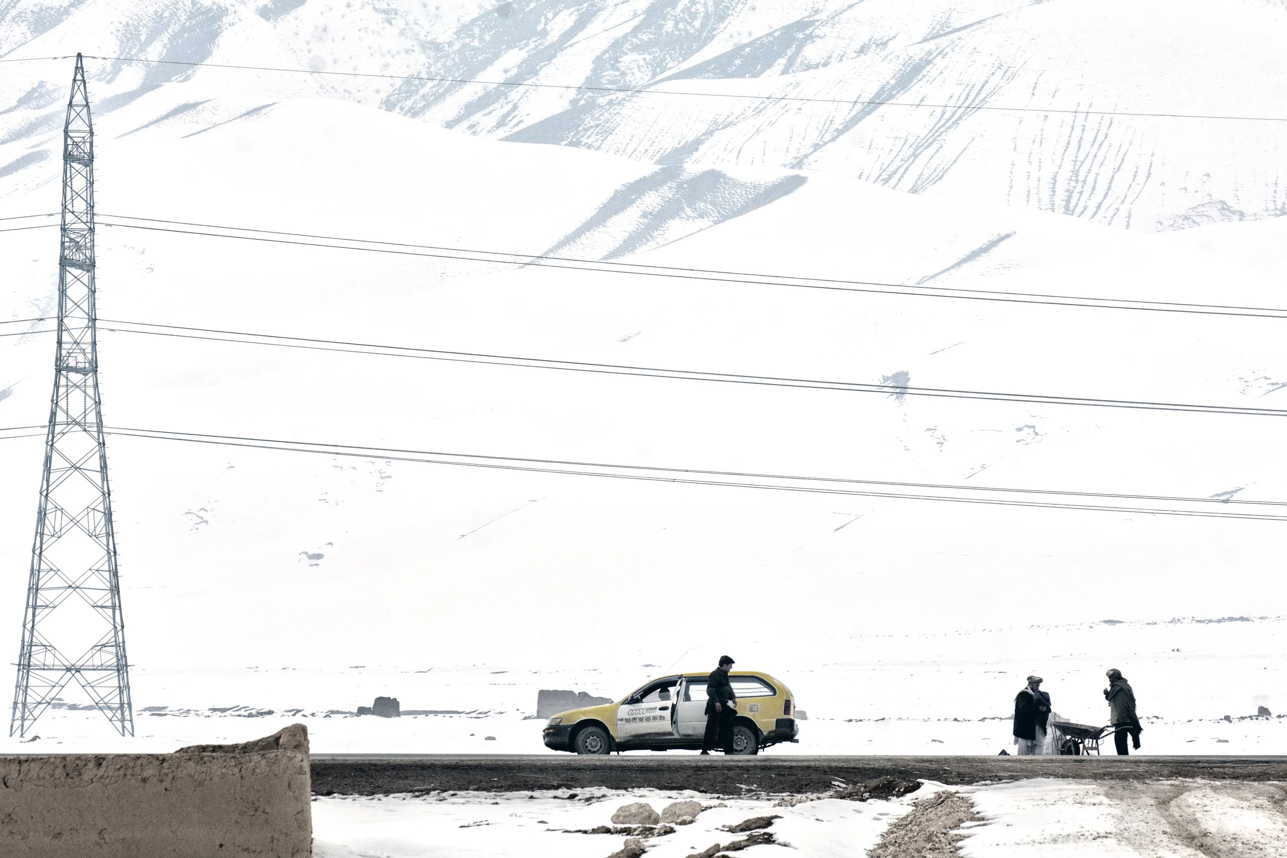 Cars wait outside a displacement camp near Pul i Khumri , Baghlan Province, Afghanistan, February 13, 2008. (Photo/Mark Pearson)