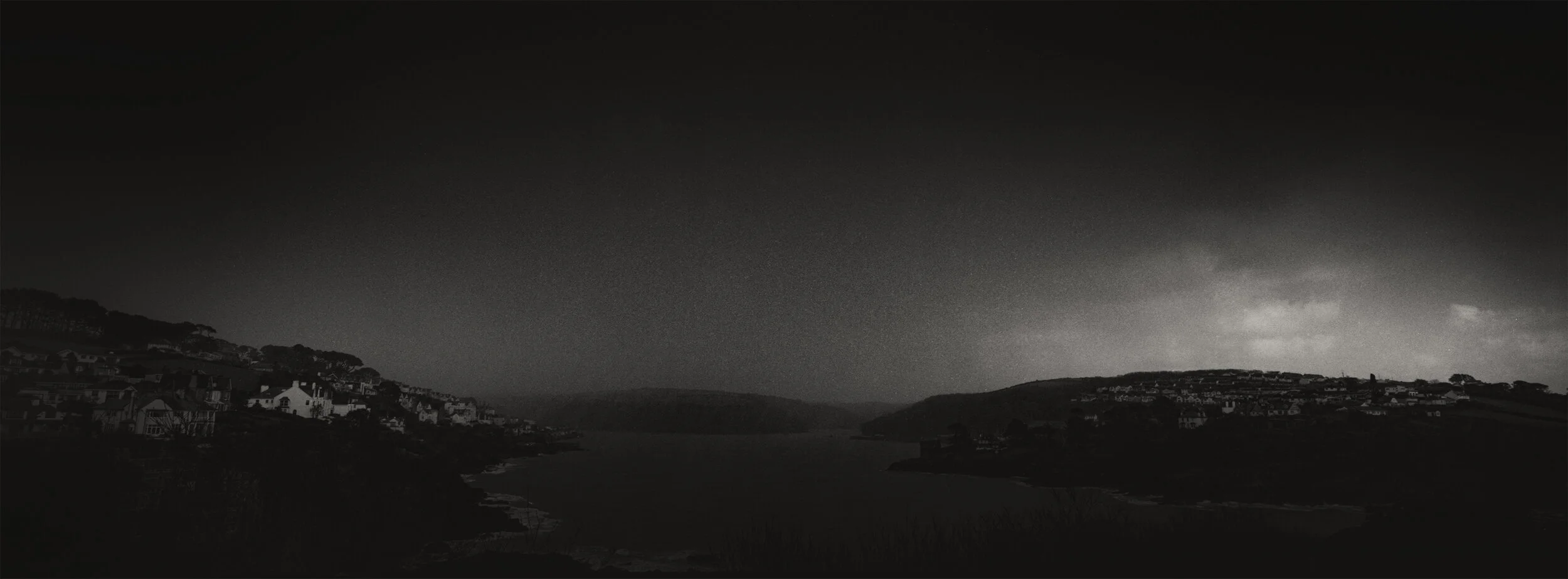 During the Second World War, Fowey was the centre for air-sea rescue and also one of the places from which the D-Day invasions were launched. View of the entrance to the deep sea port during a sudden hail storm, Fowey harbour, Cornwall on Saturday 2…